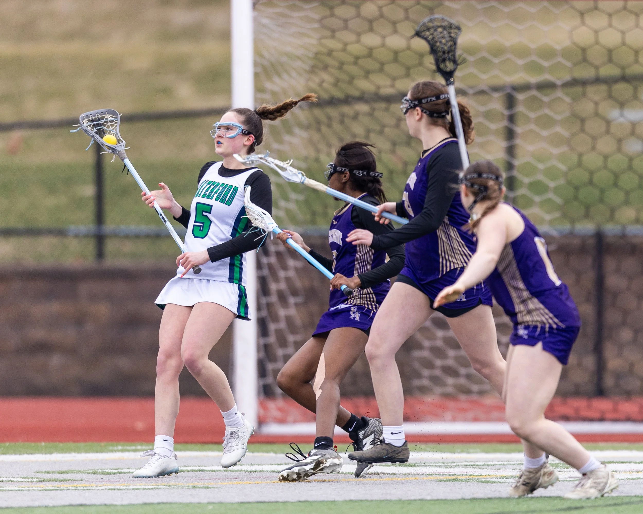 #5 with three defenders around her