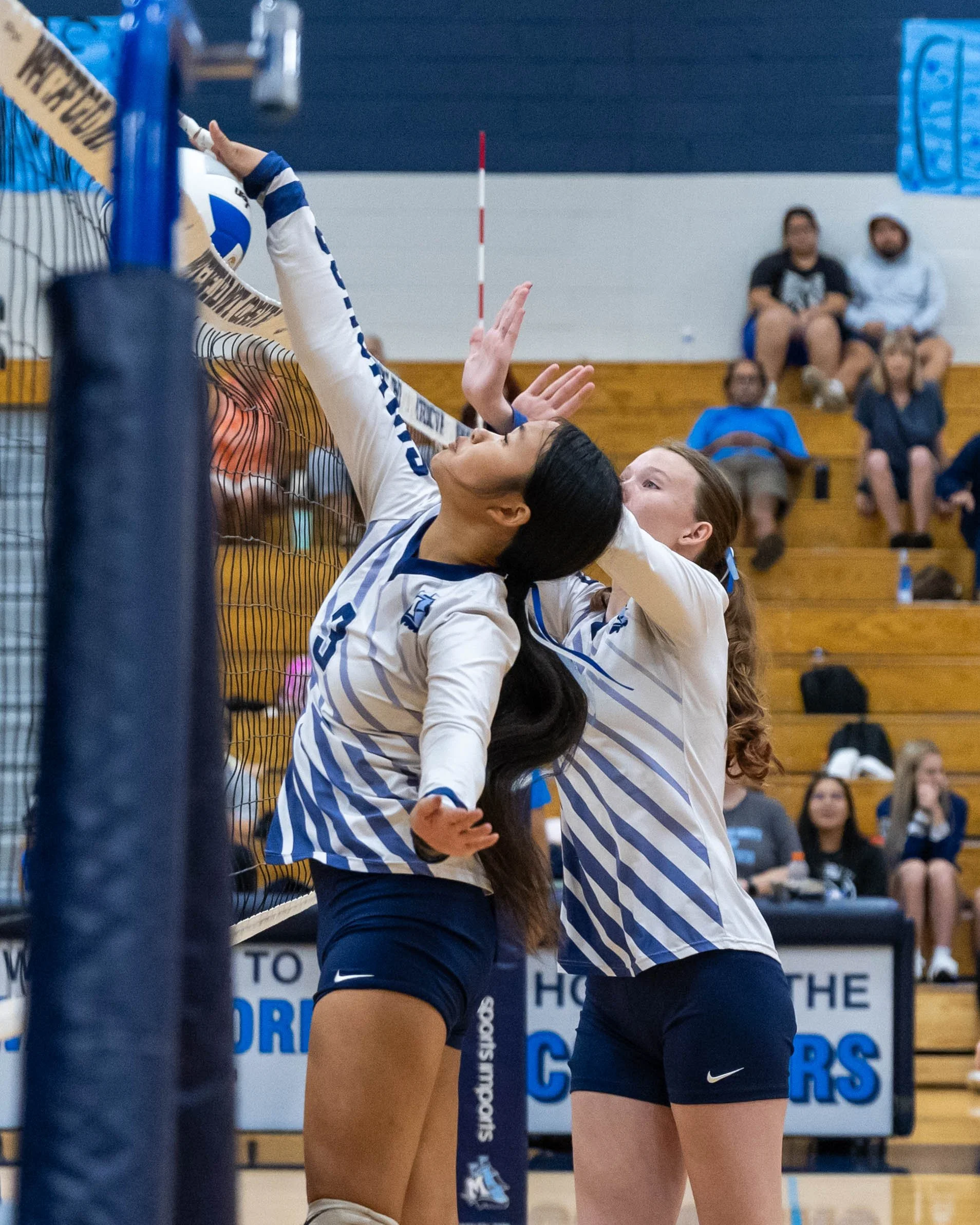 WM #3 spikes the ball at the net