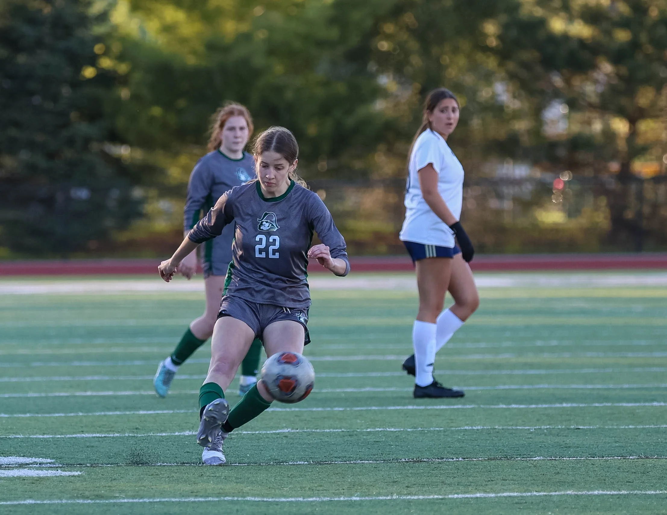 #22 kicks the ball