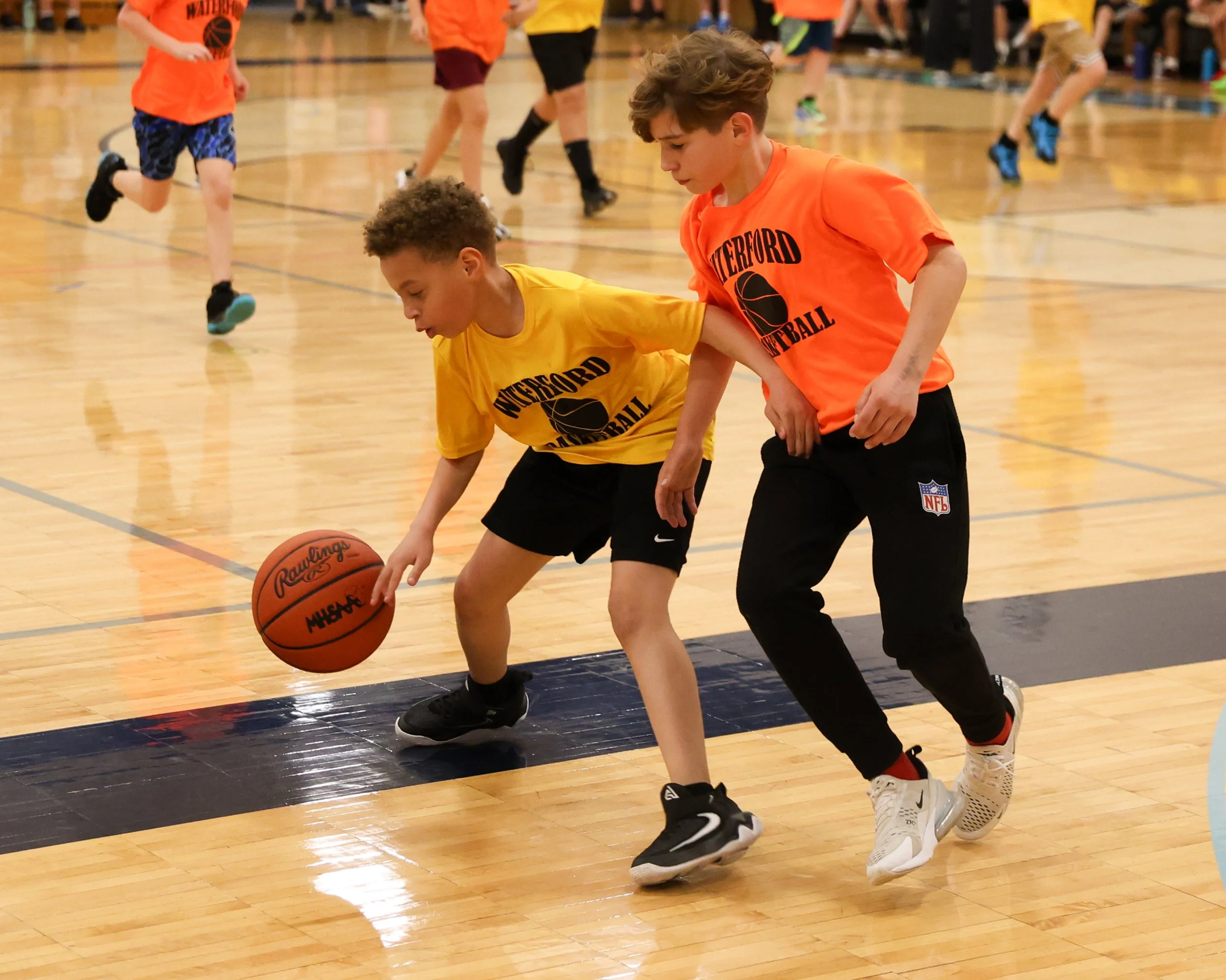 Schoolcraft boy dribbles the ball guarded by Knudsen boy