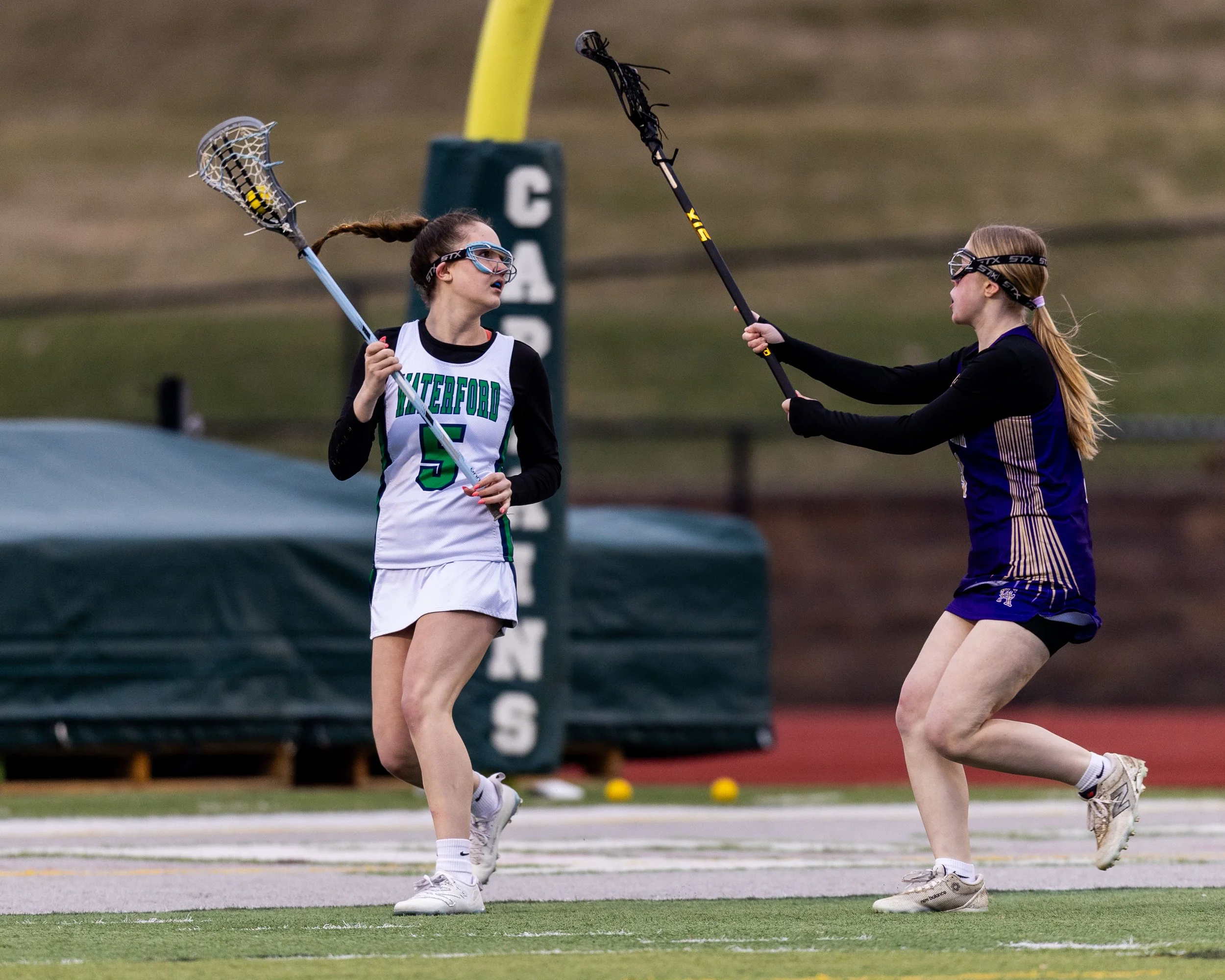 #5 holds the ball with a defender