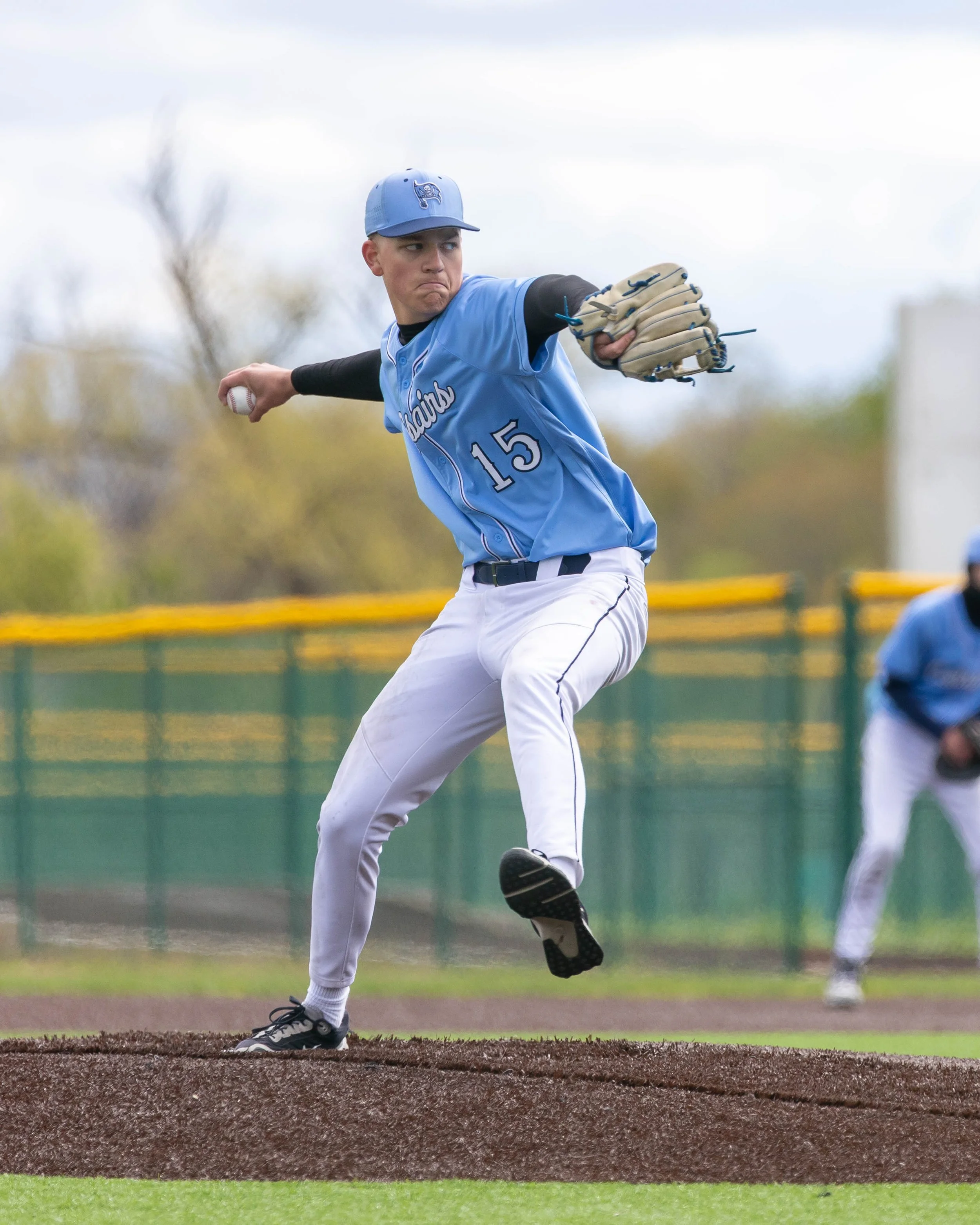Mott #15 pitches the ball