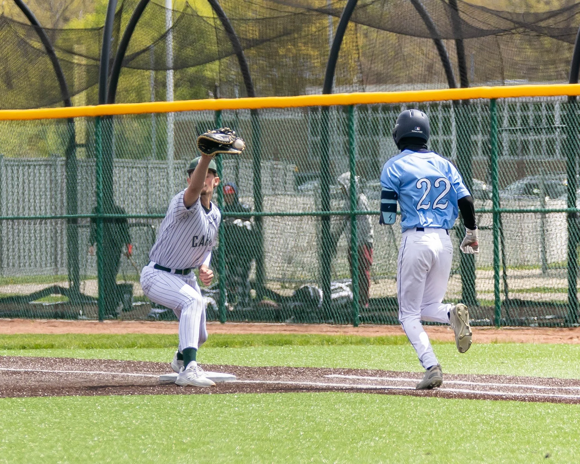 Kettering #11 catches the ball at 1st base