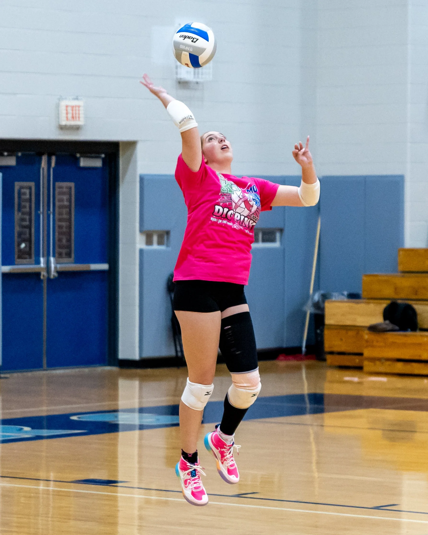 Kettering player serves the ball