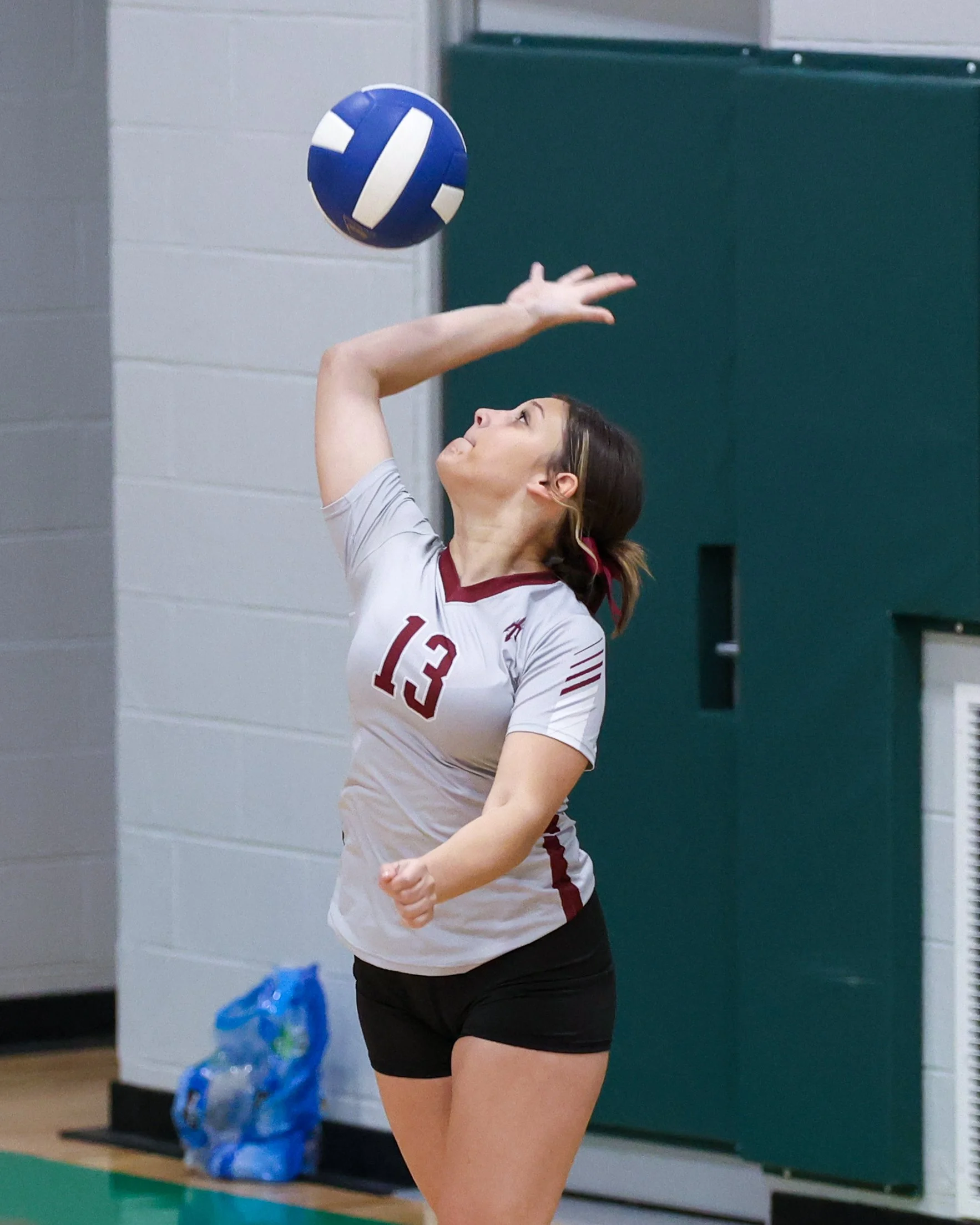 Mason girl serves the ball