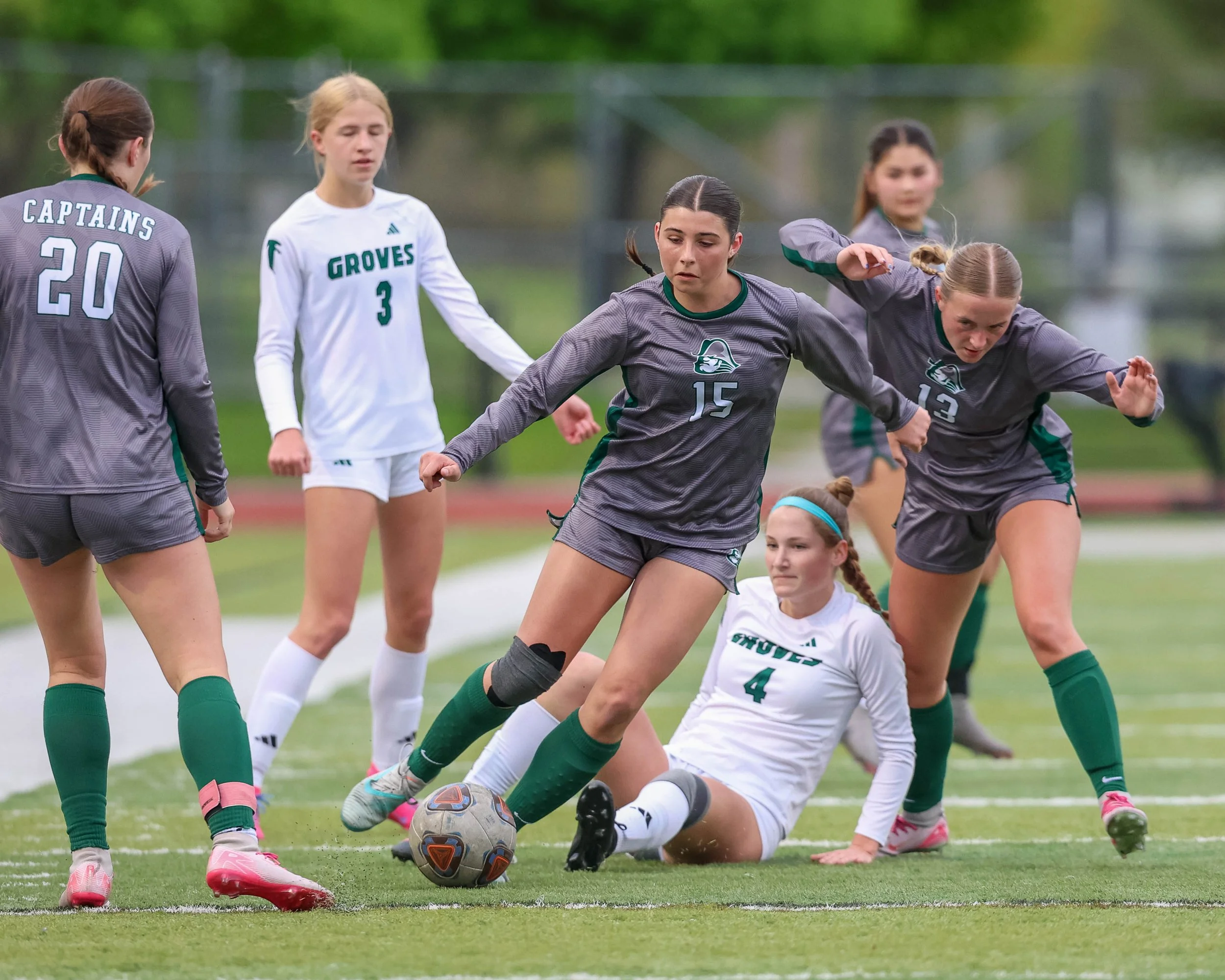 #15 gets the ball in a group of players
