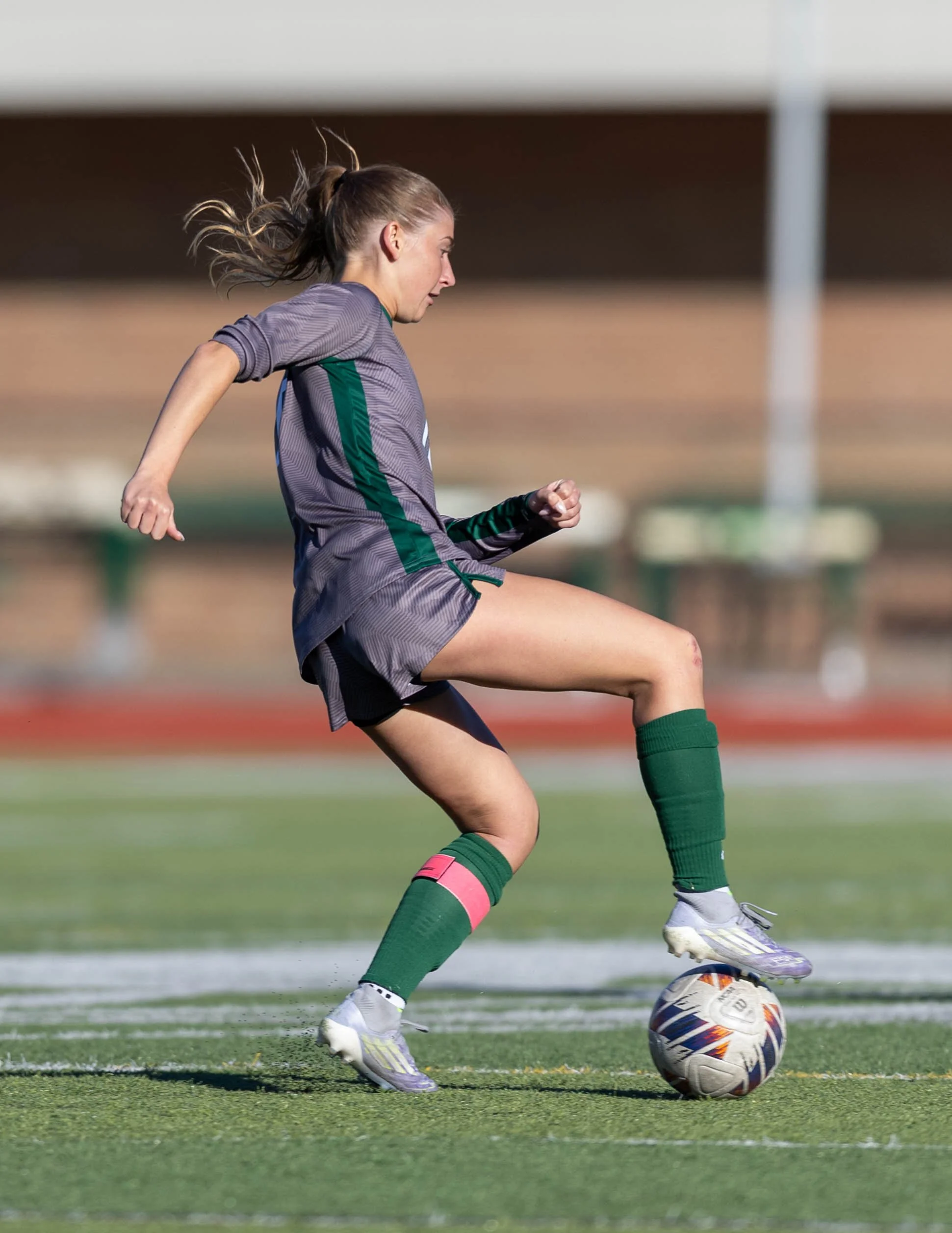 #10 controls the ball with her foot