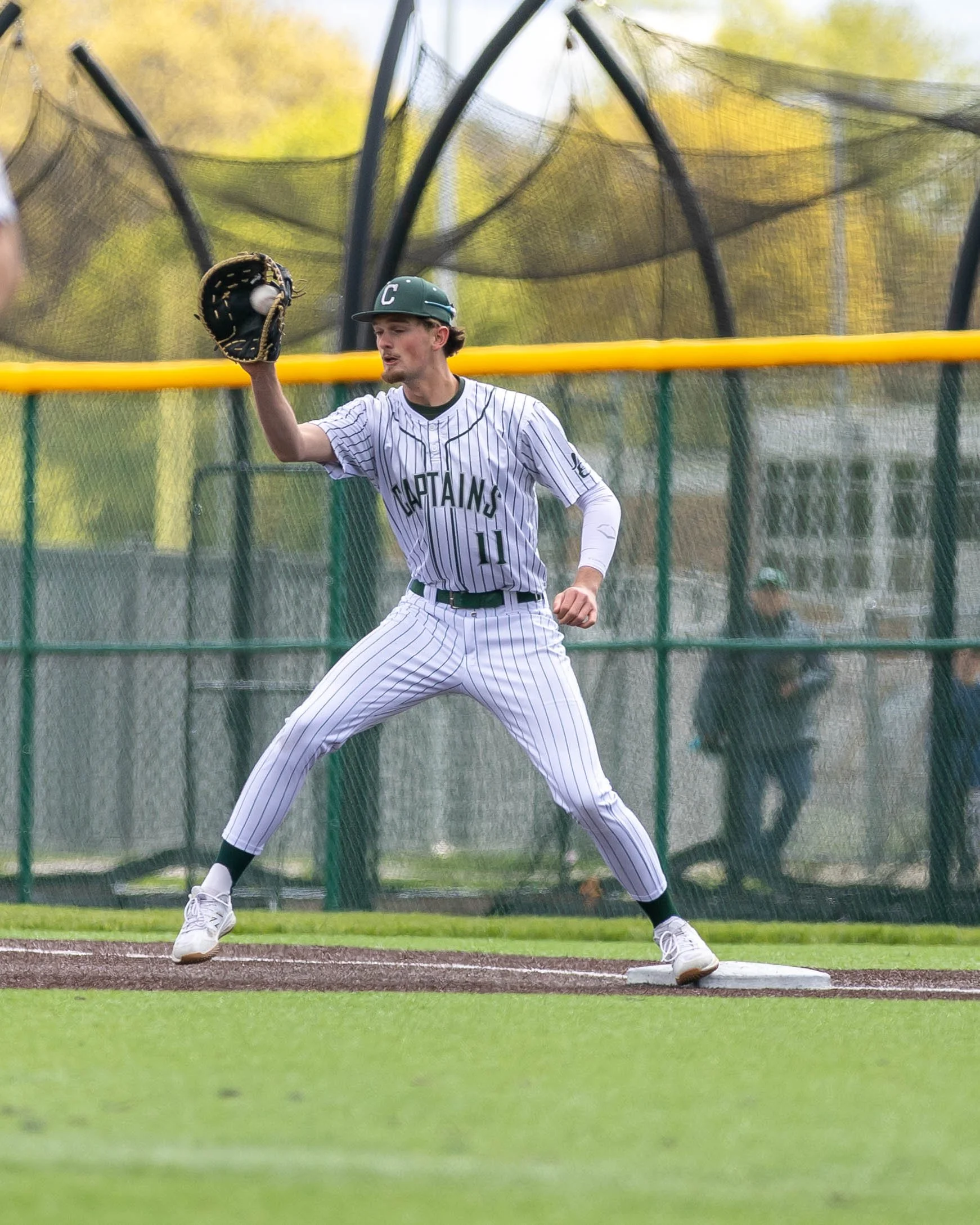 Kettering #11 catches the ball at 1st base