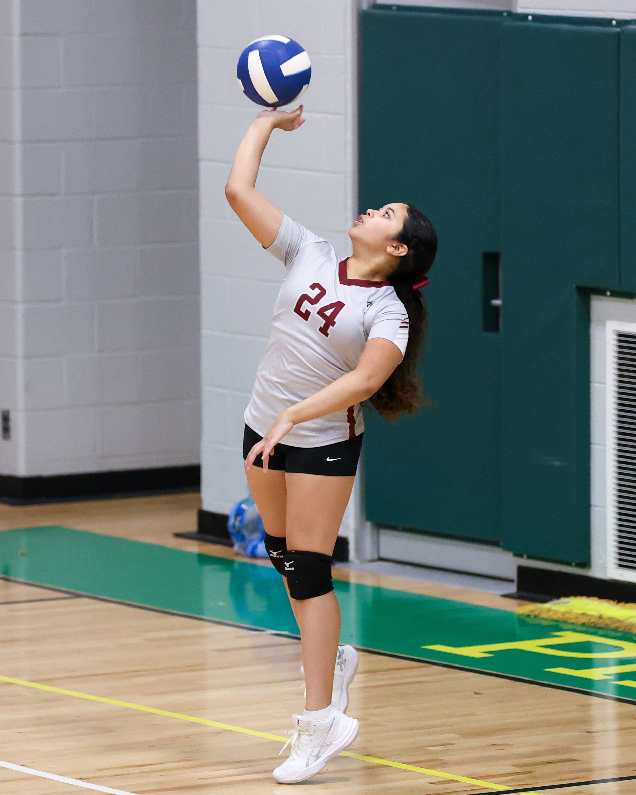 Mason girl serves the ball