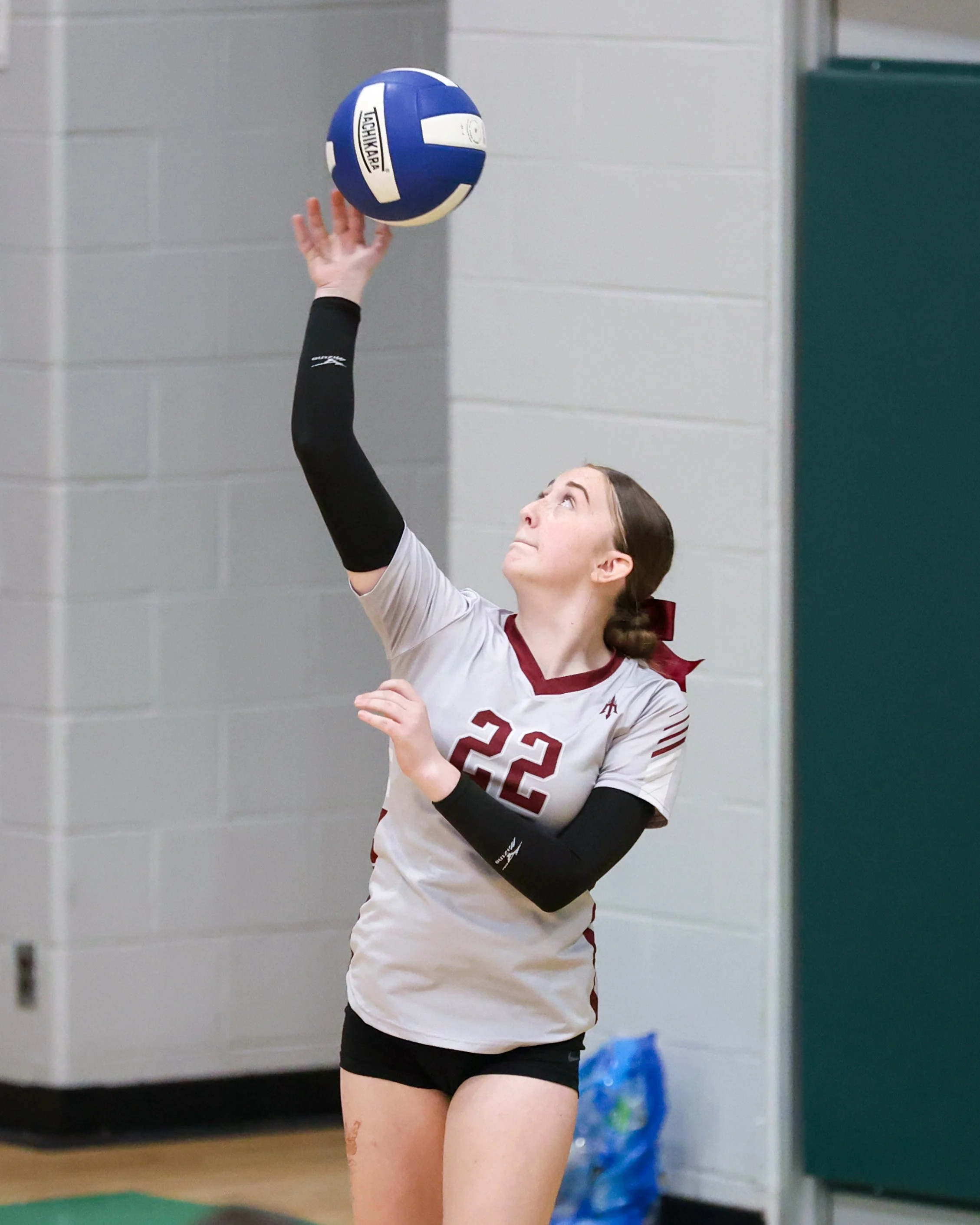 Mason girl serves the ball
