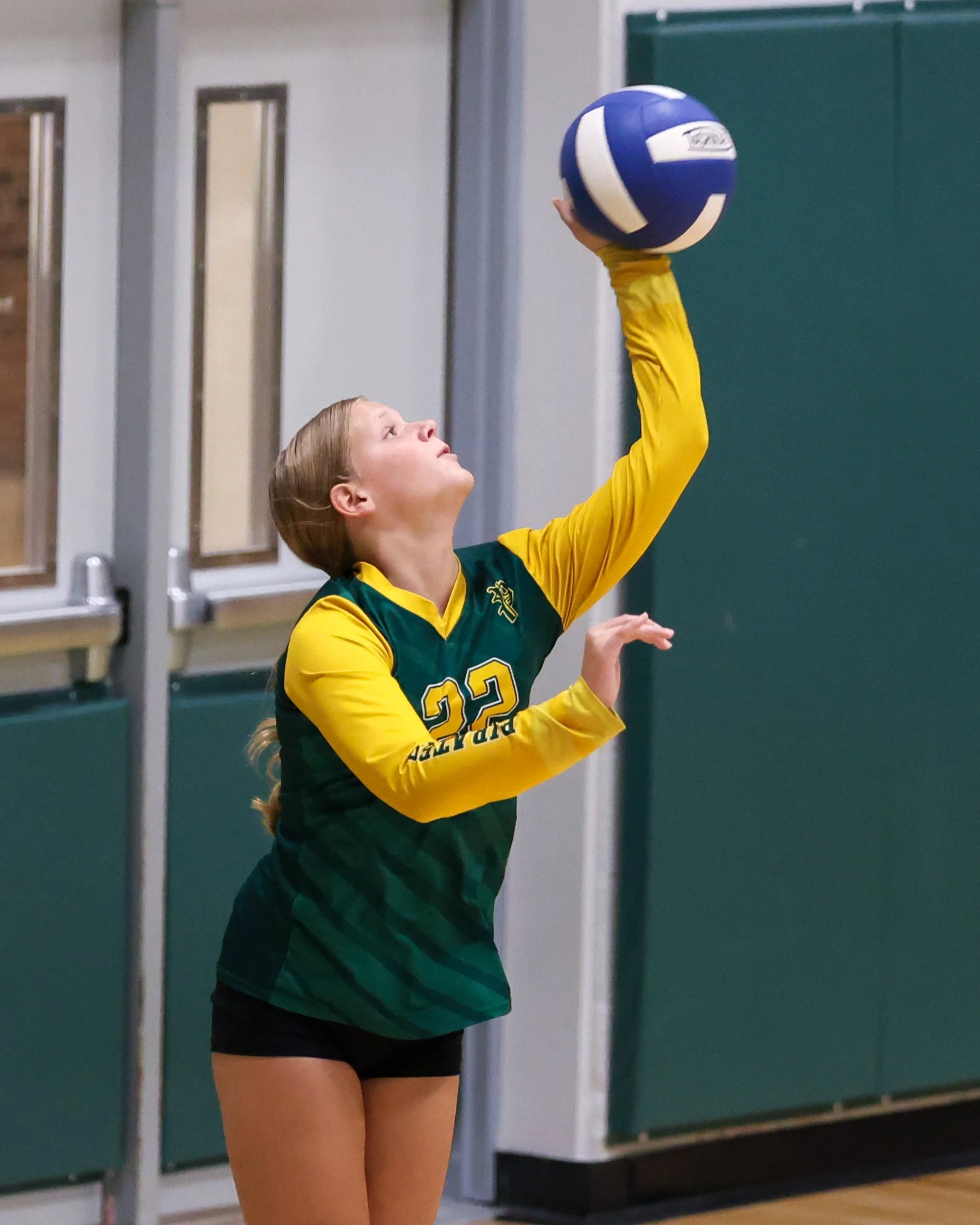 Pierce girl serves the ball