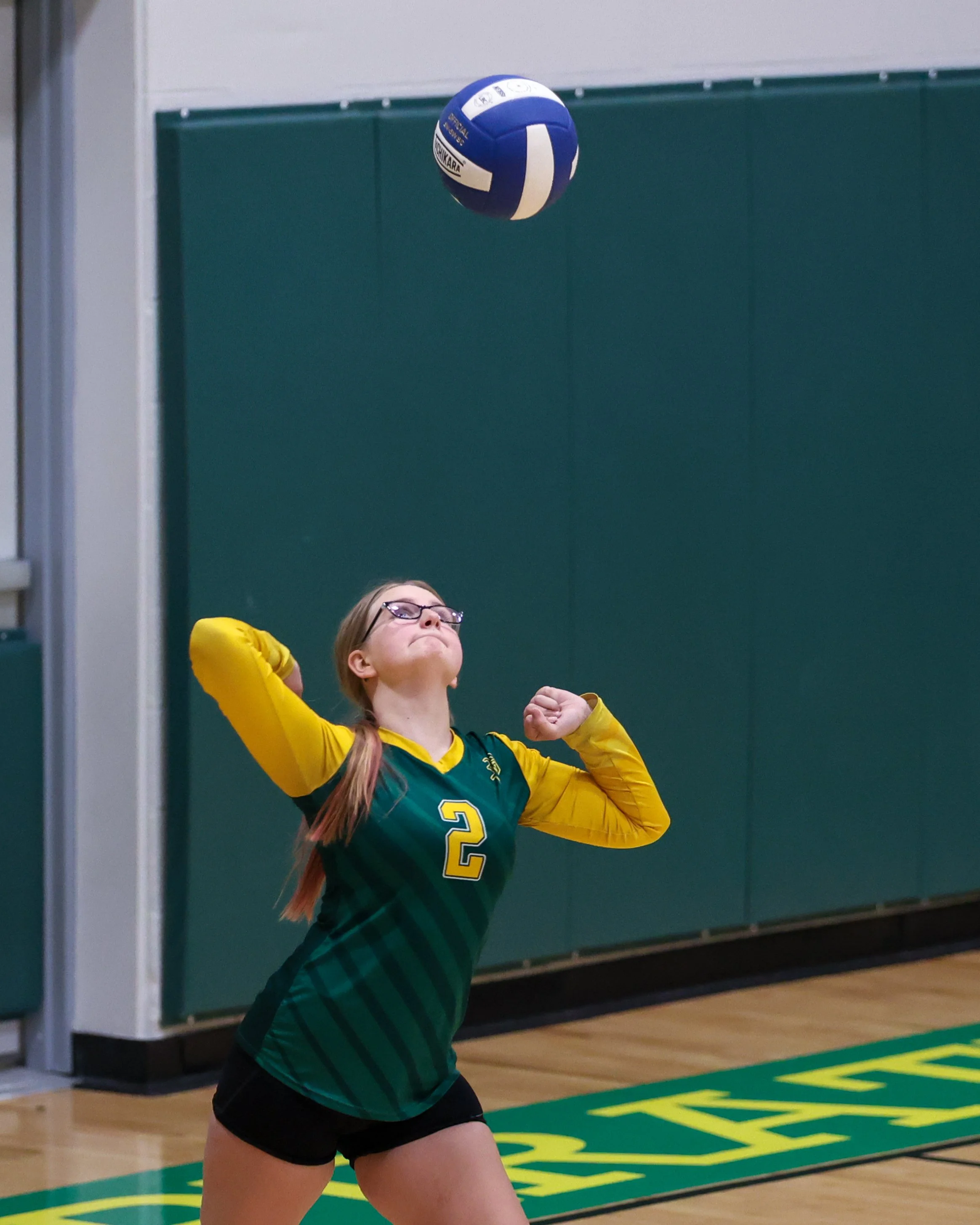 Pierce girl serves the ball