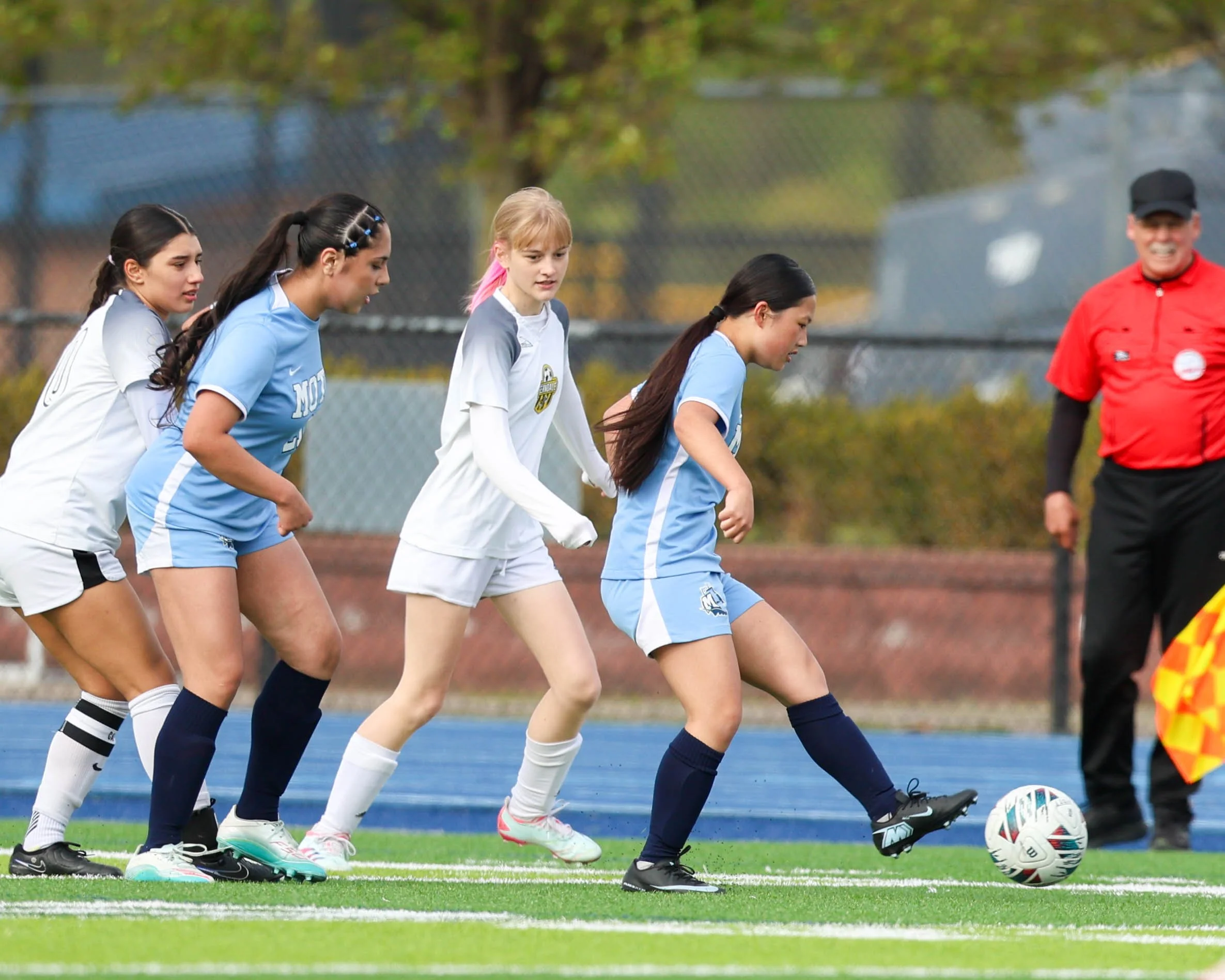 #6 kicks the passes the ball