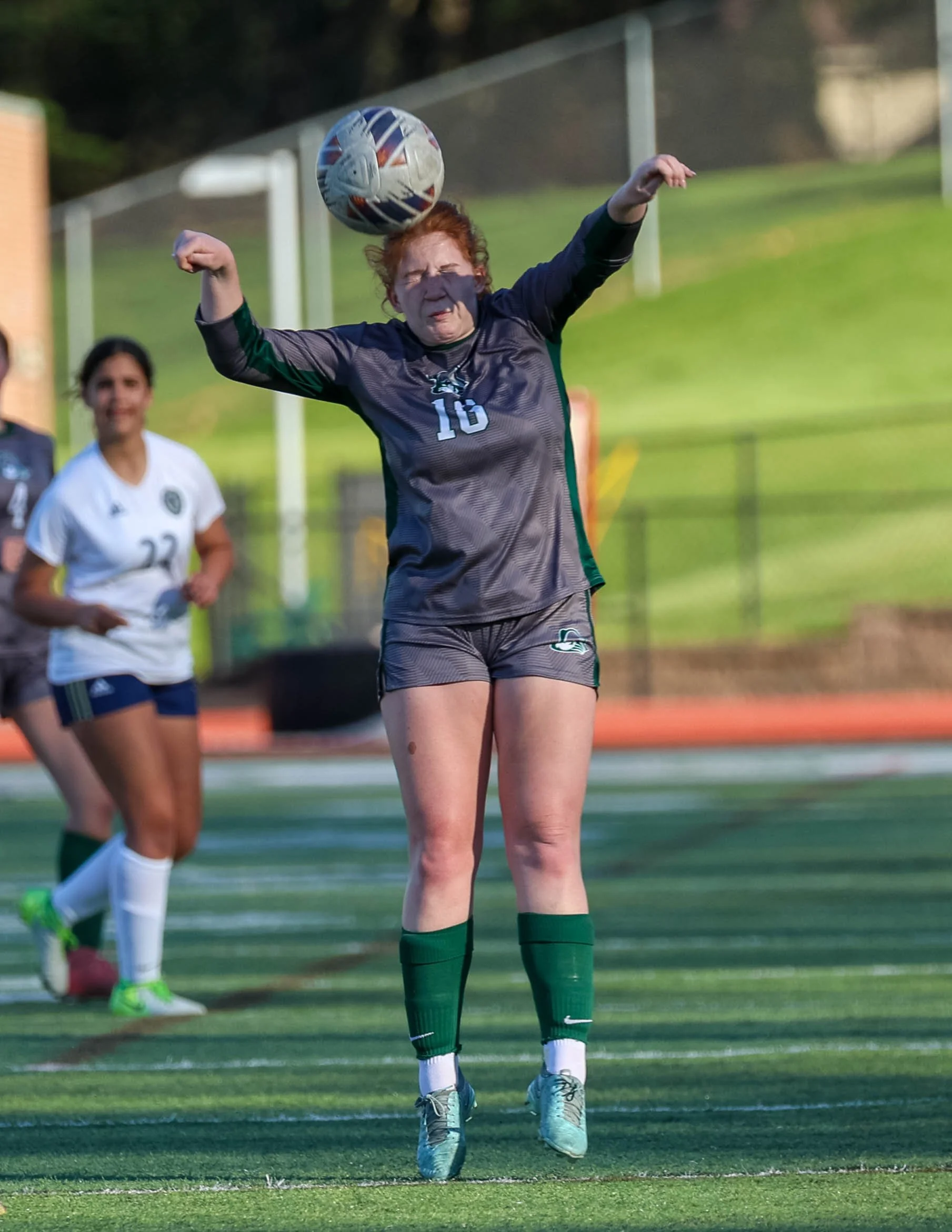 #16 heads the ball