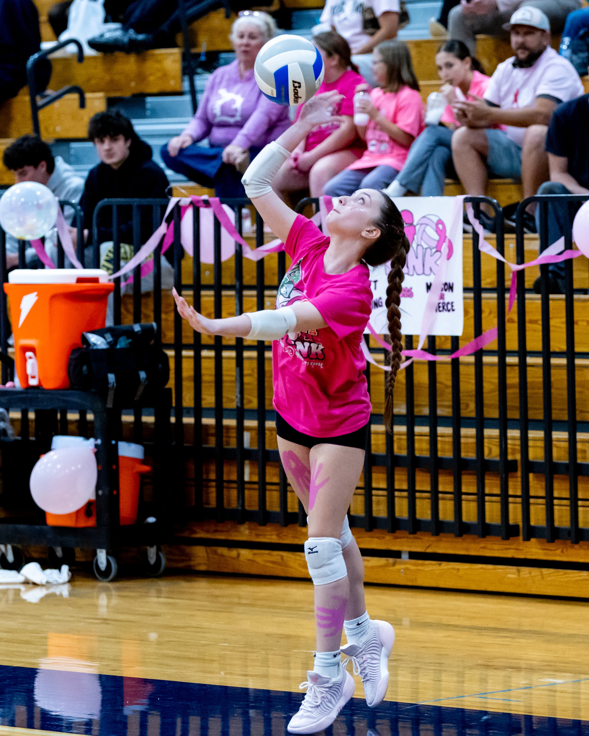Kettering player serves the ball