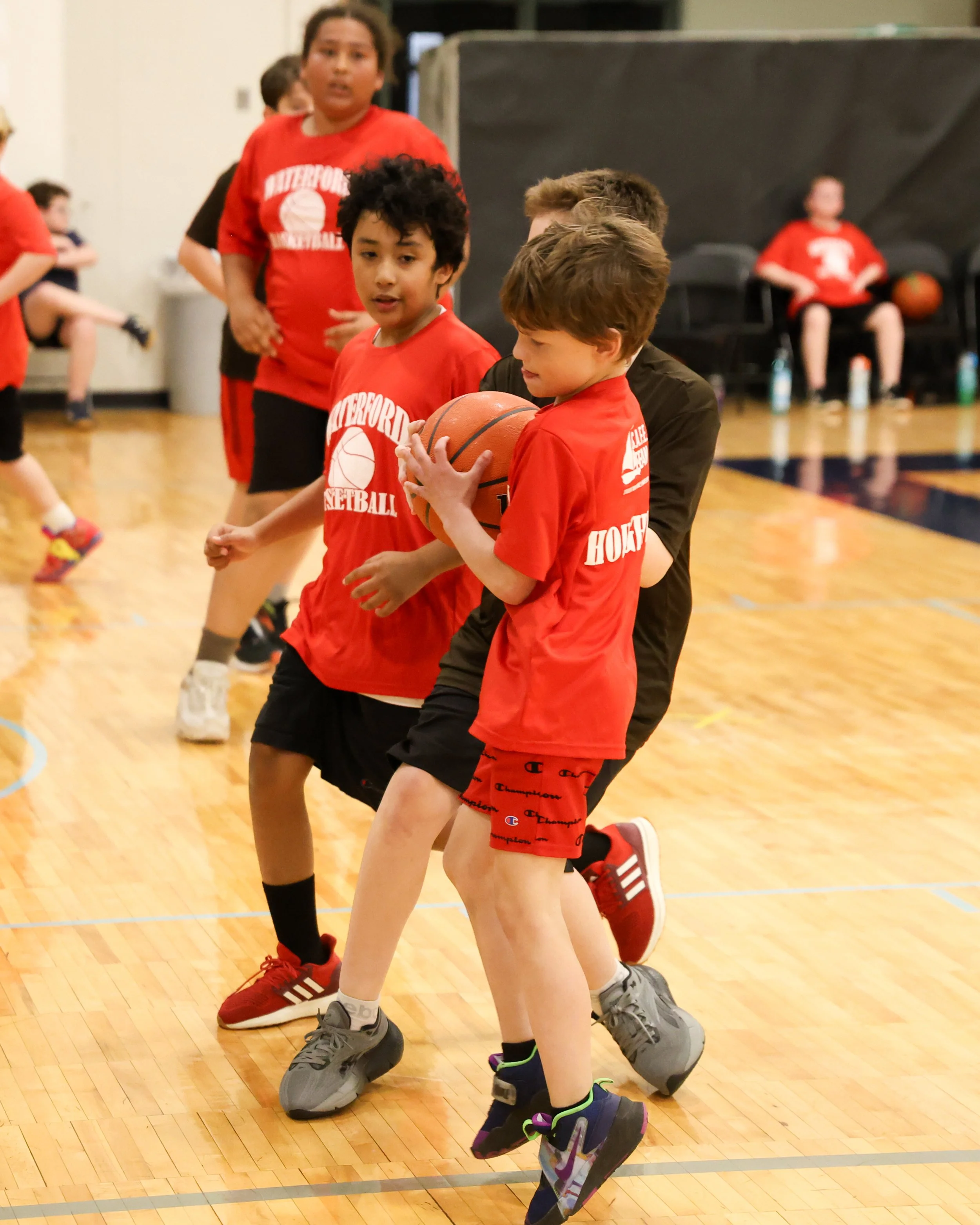 Houghton boy holding the ball with Haviland boy grabbing the ball