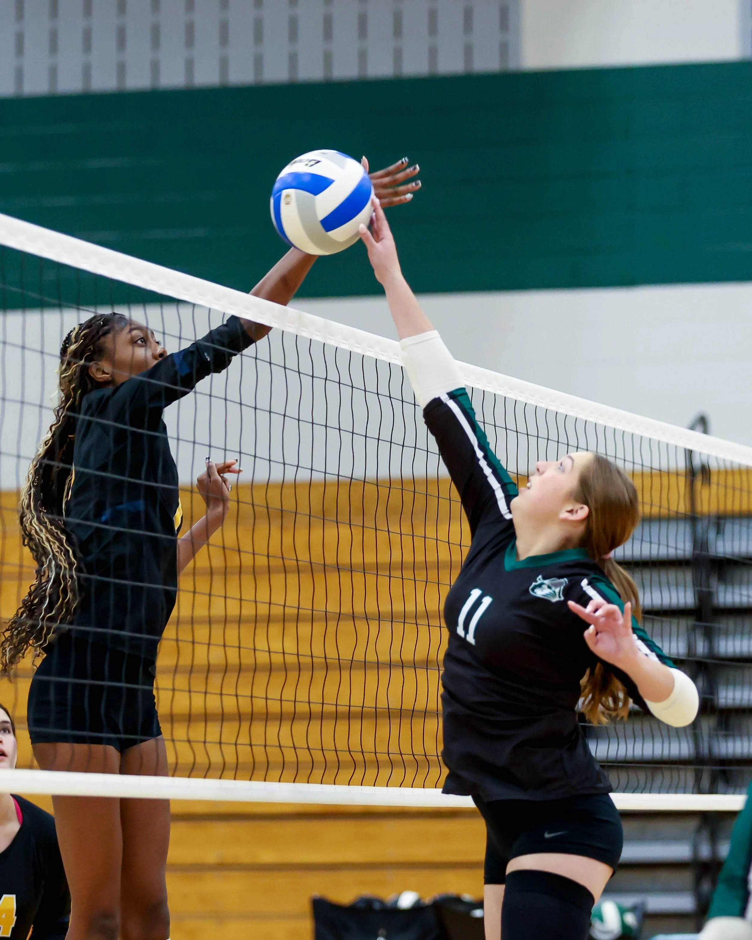 Kettering #11 hits the ball towards the net