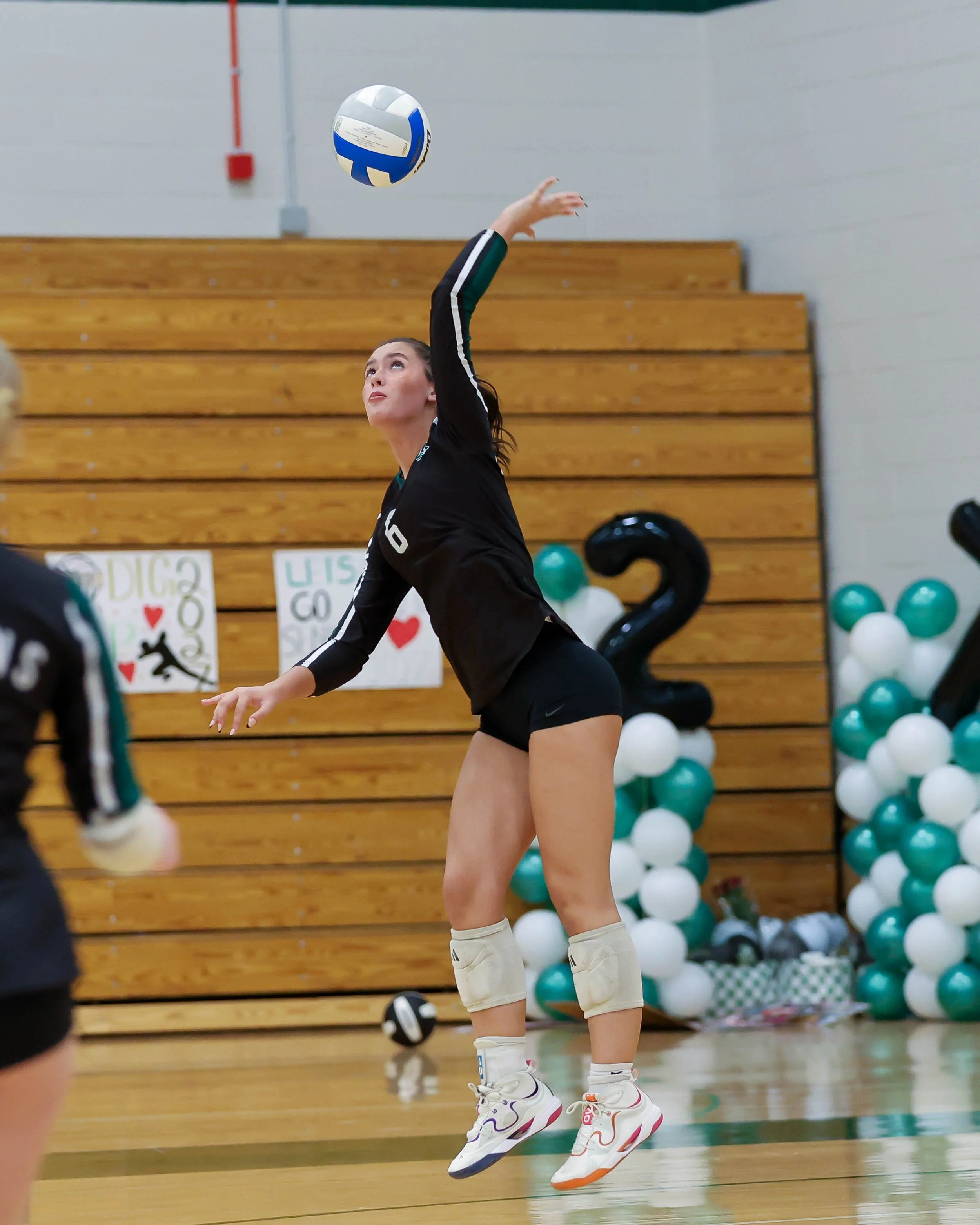 Kettering #6 serves the ball