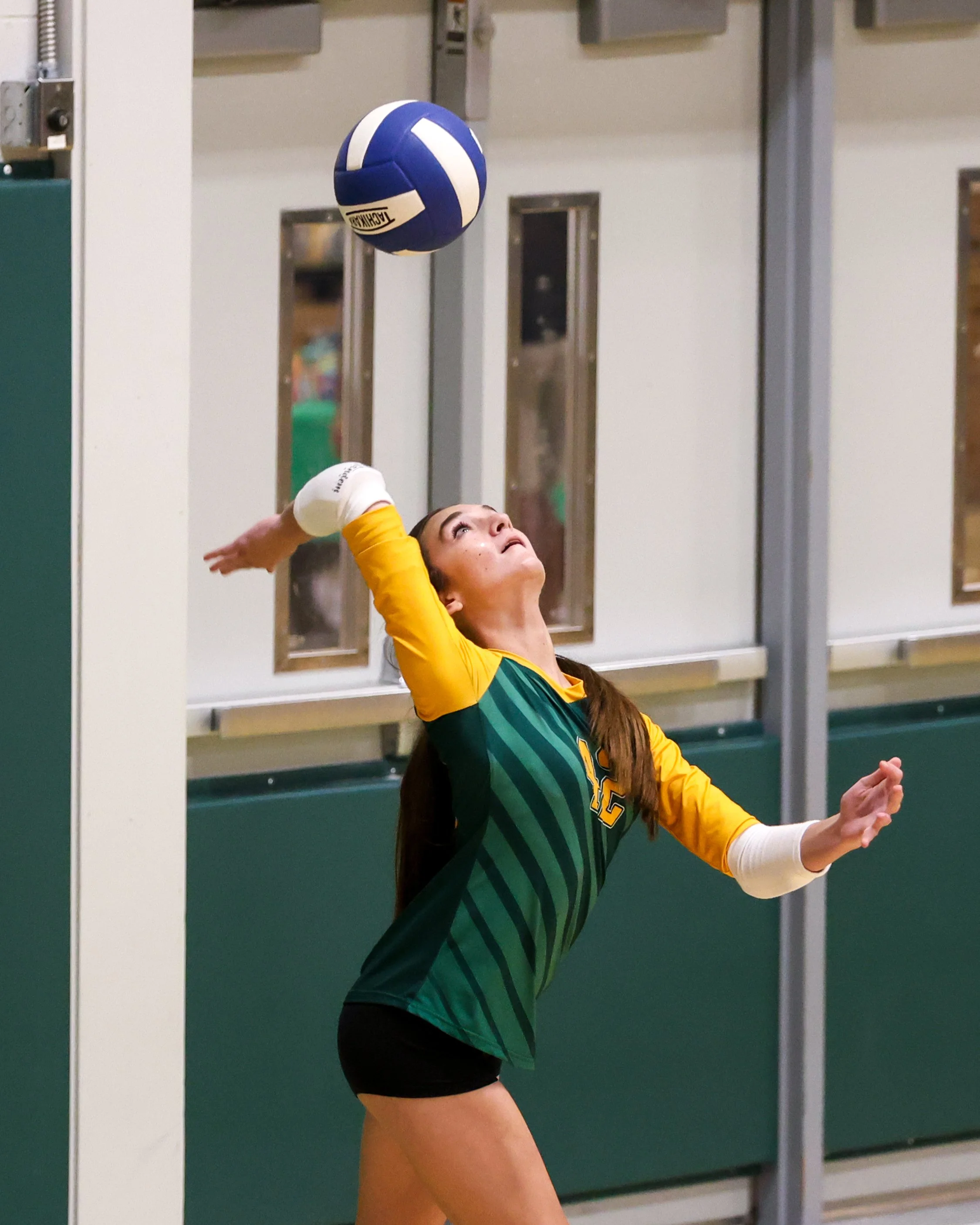 Pierce girl serves the ball