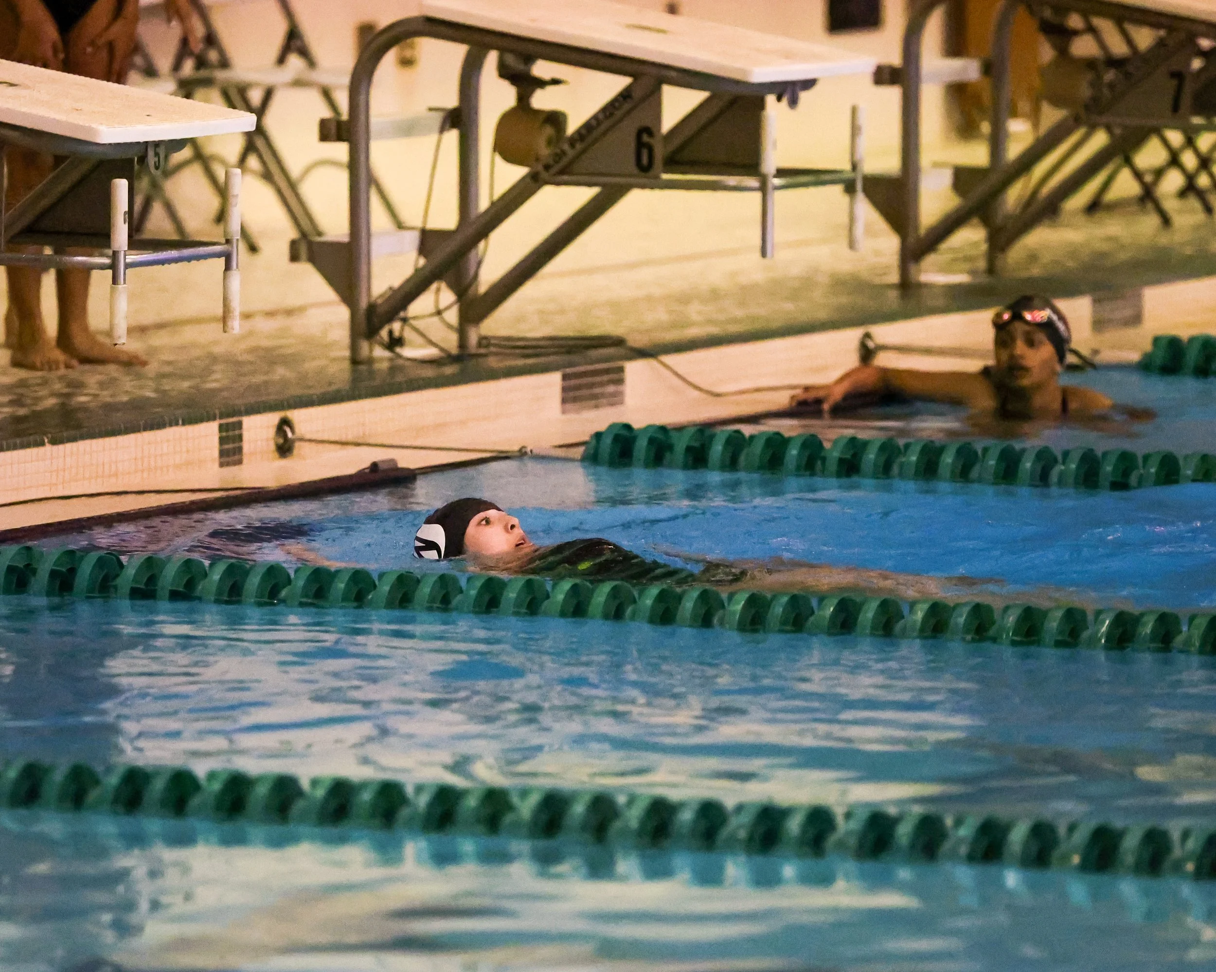 WU swimmer finishes the backstroke