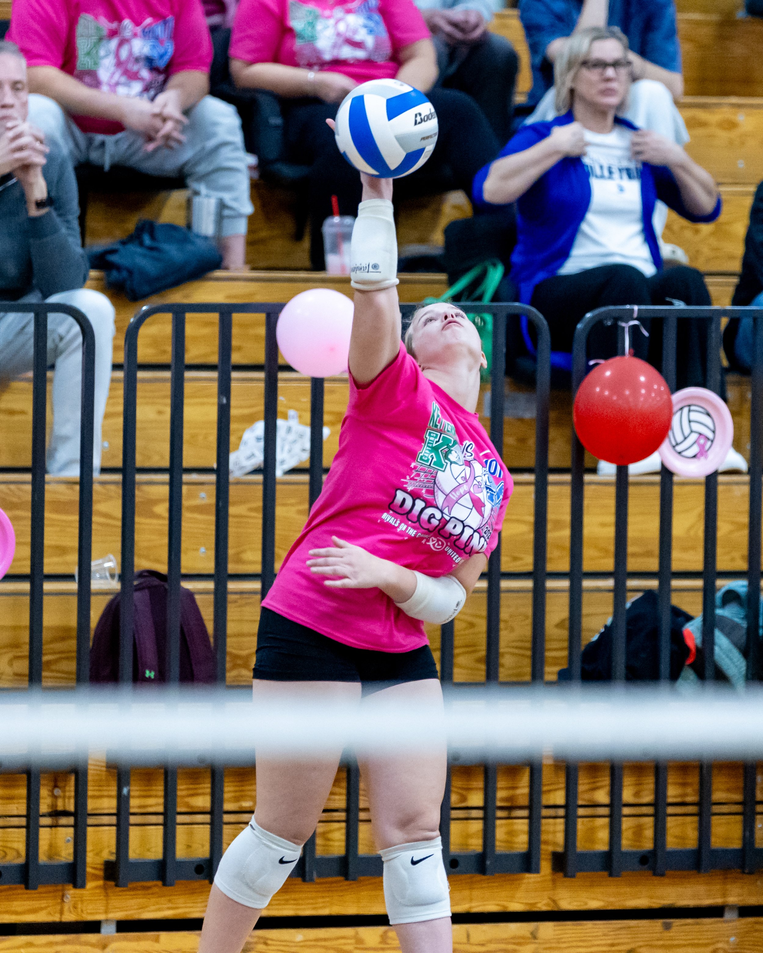 Kettering player serves the ball