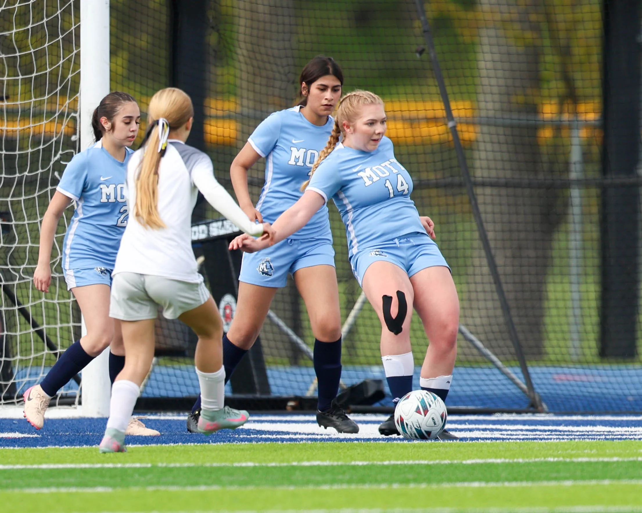 #14 kicks the ball 