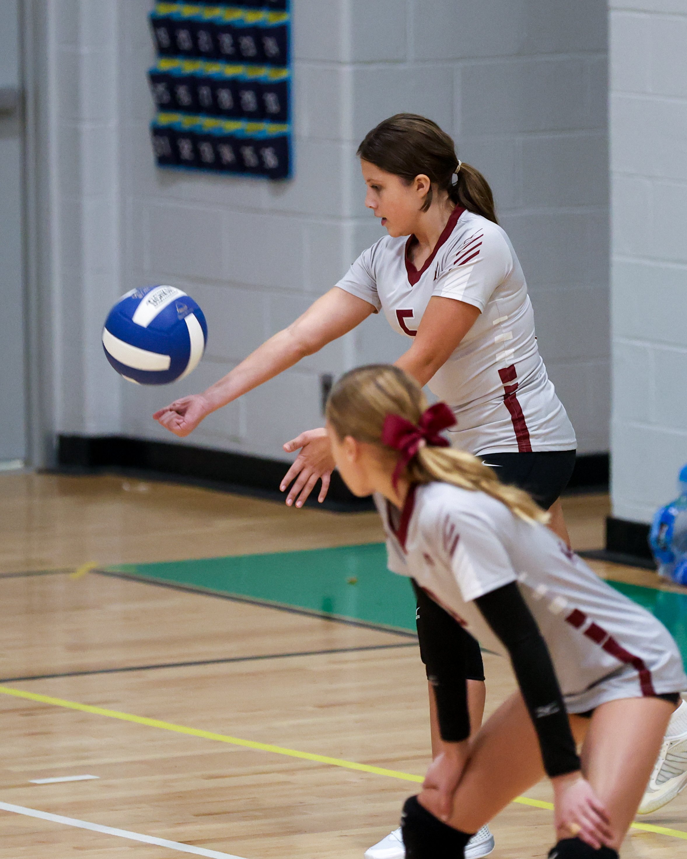 Mason girl serves the ball