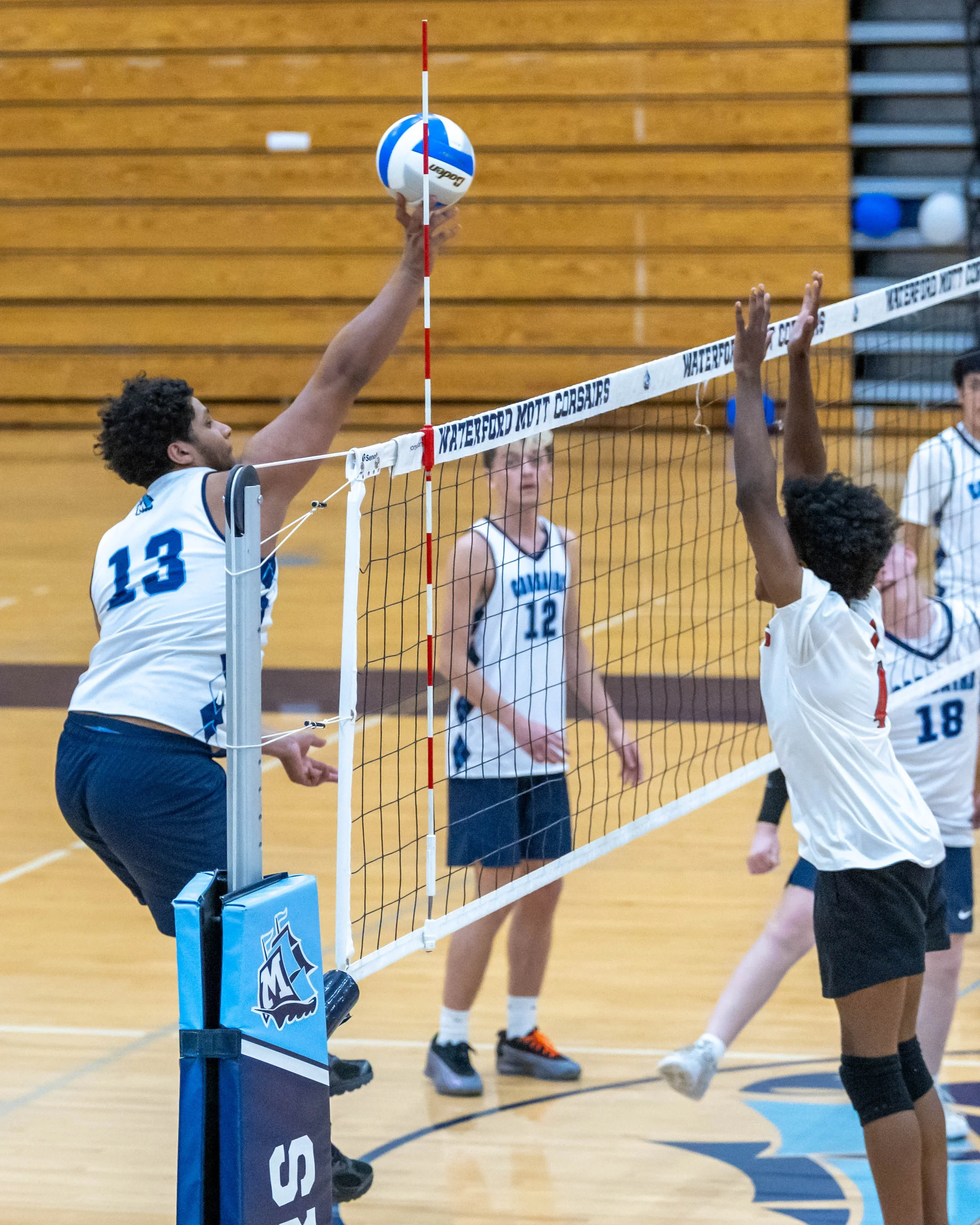 #13 hits the ball over the net