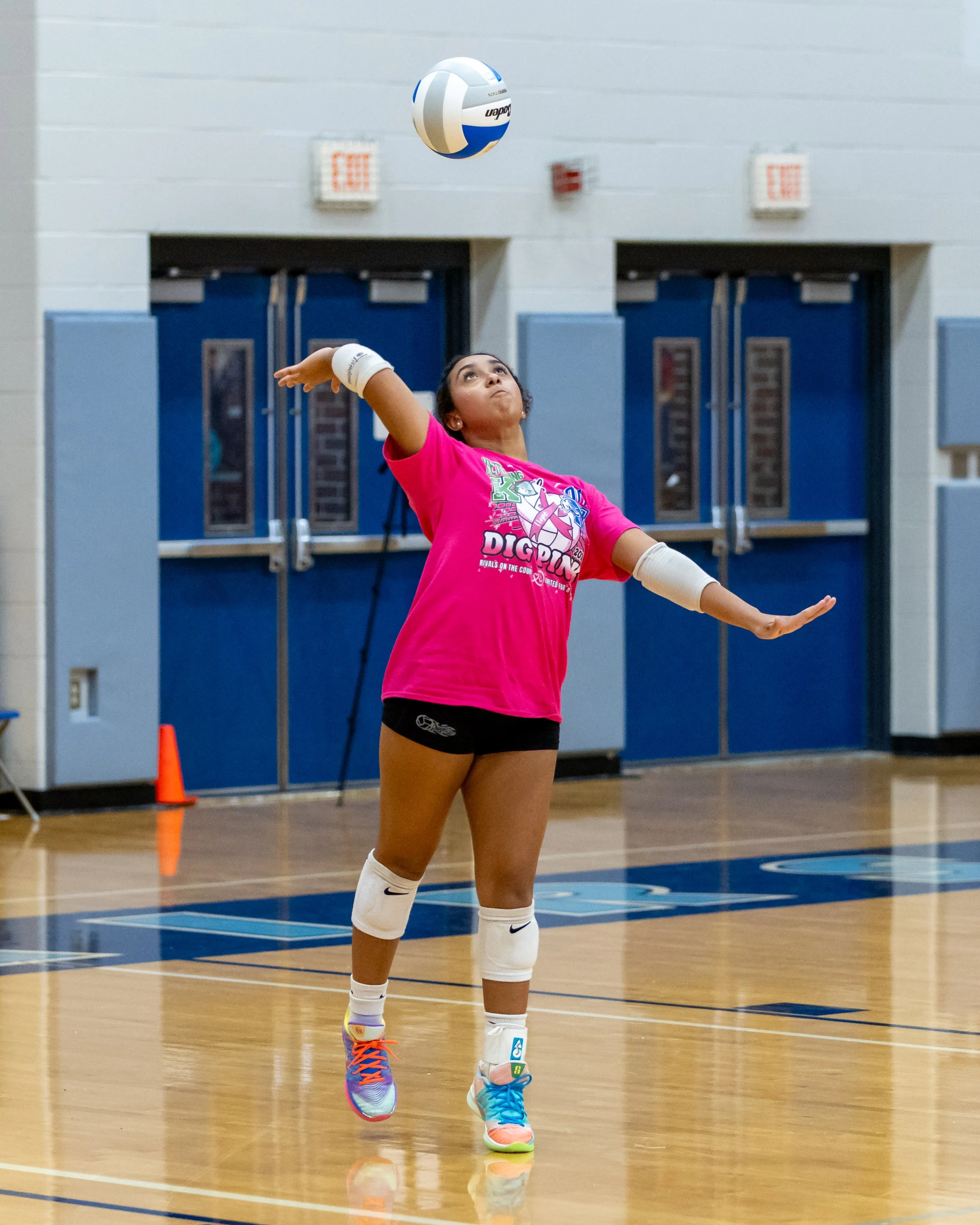 Kettering player serves the ball