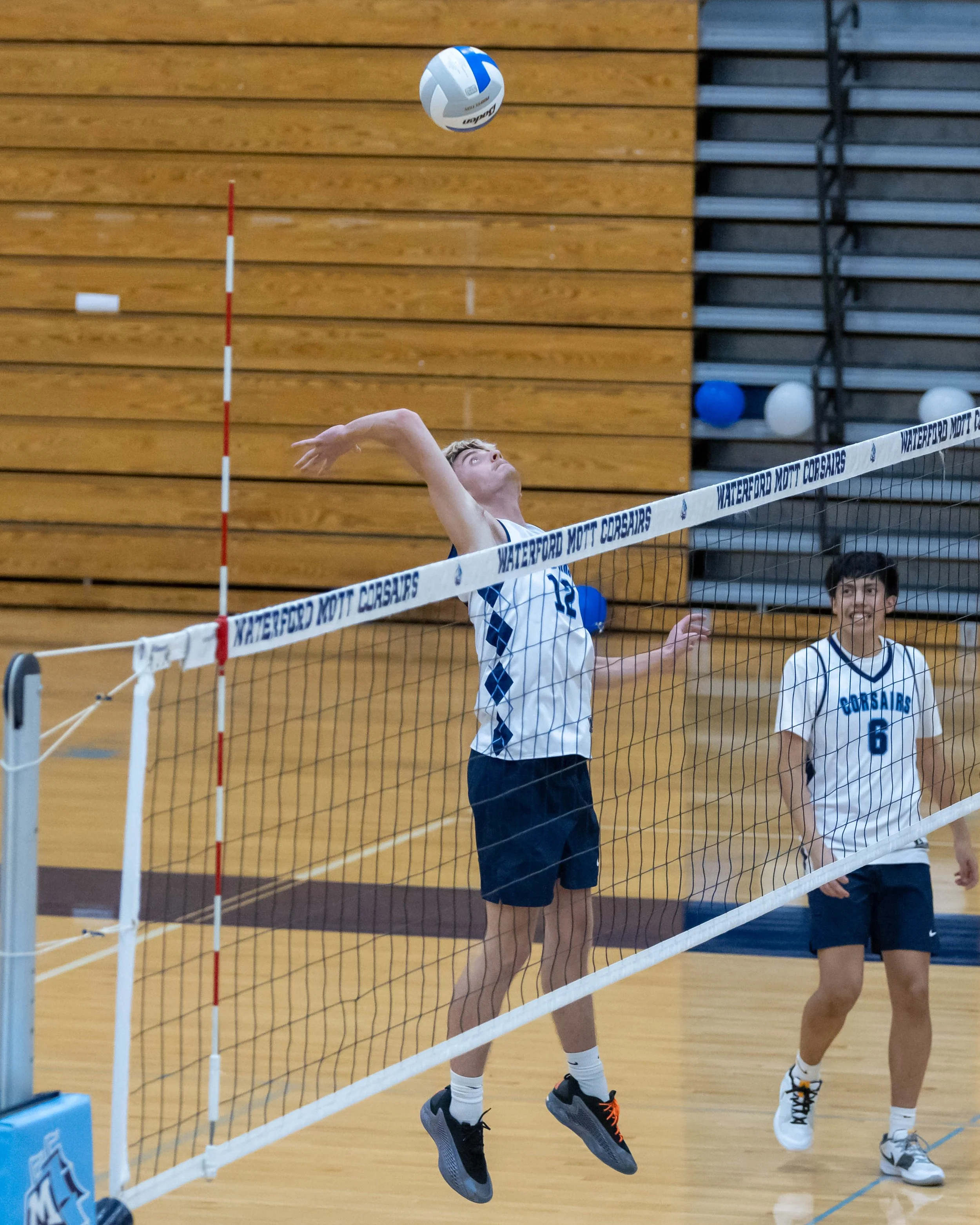 #12 goes up to spike the ball