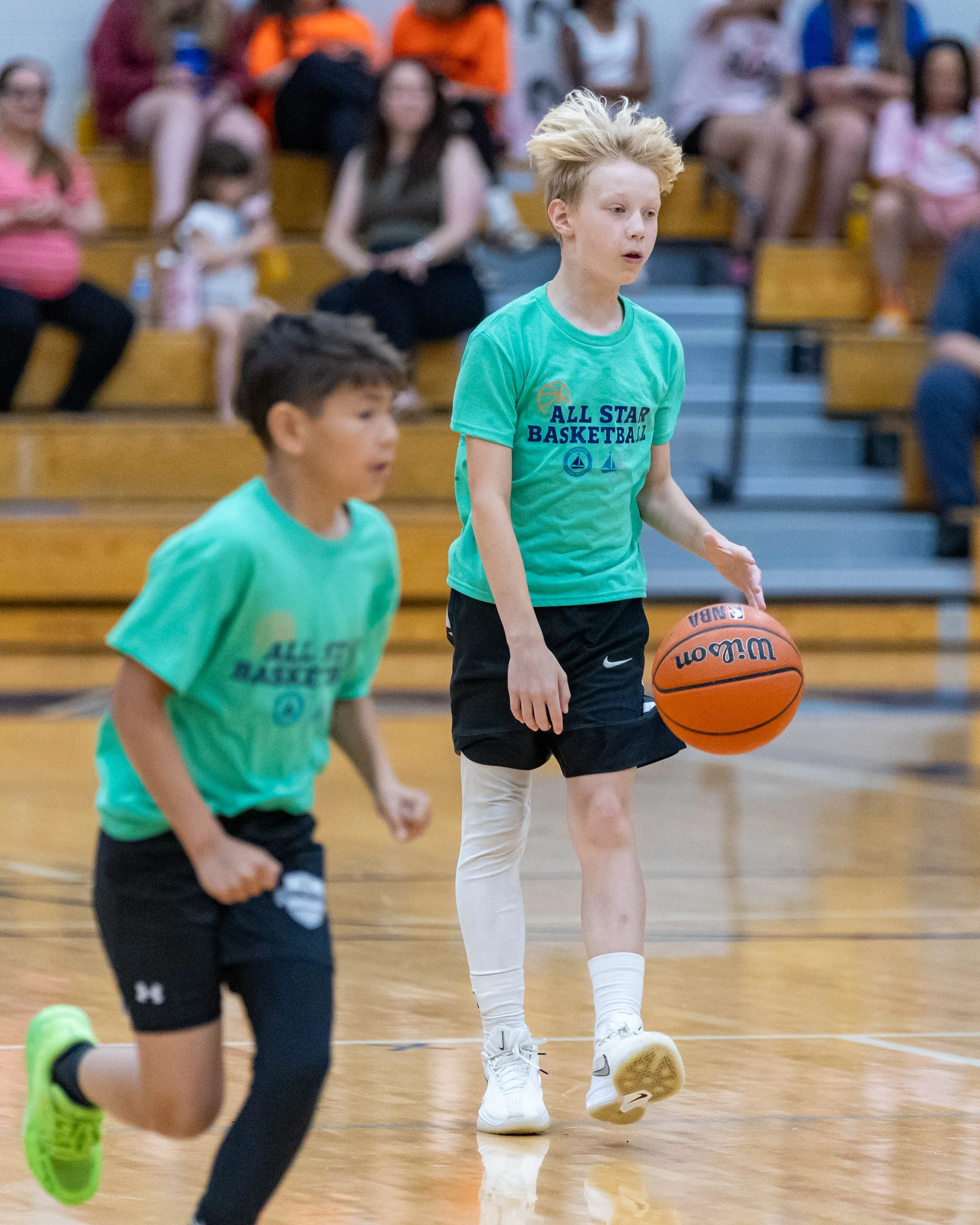 South boy dribbles the ball with teammate