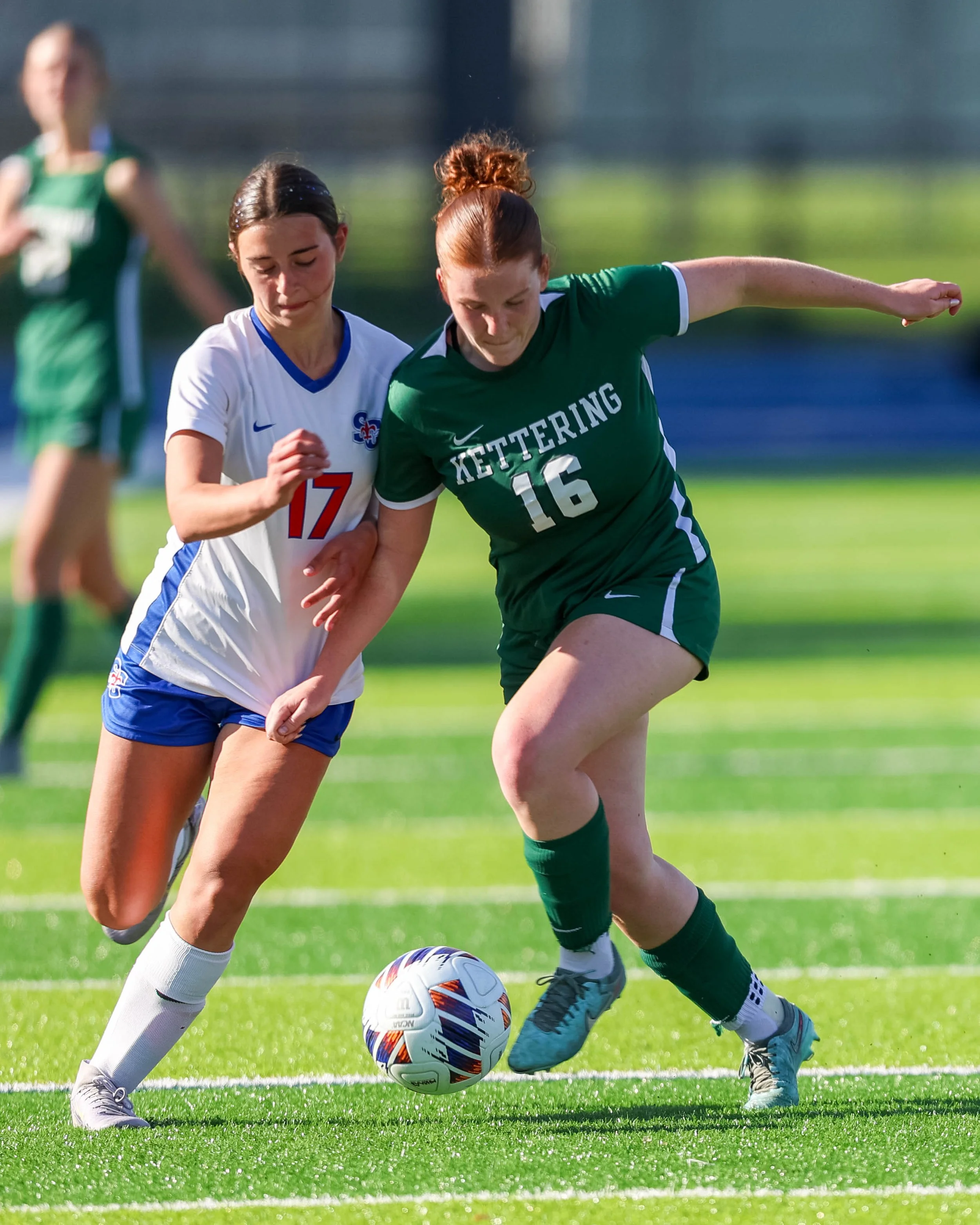 #16 fights for the ball with a OLSM player