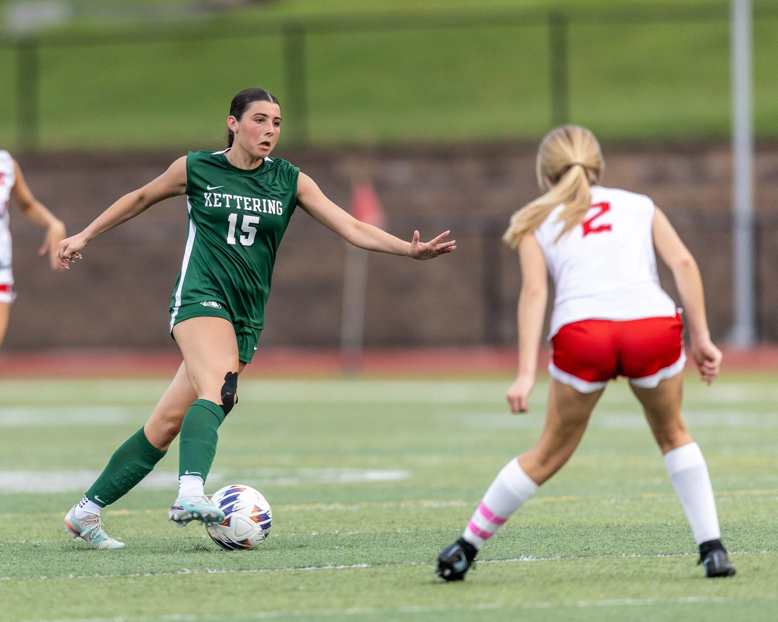 #15 dribbles the ball towards a defender
