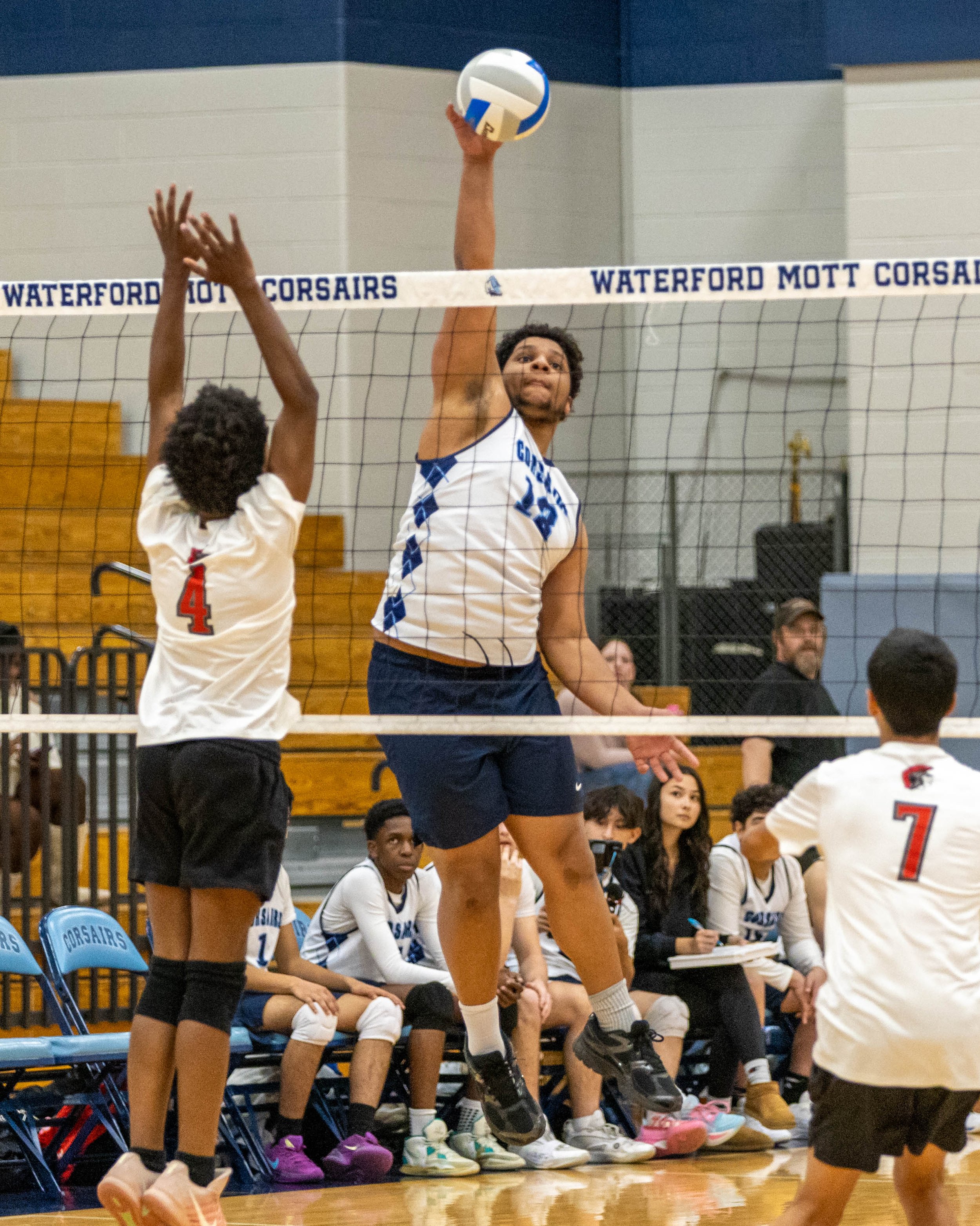 #13 hits the ball over the net