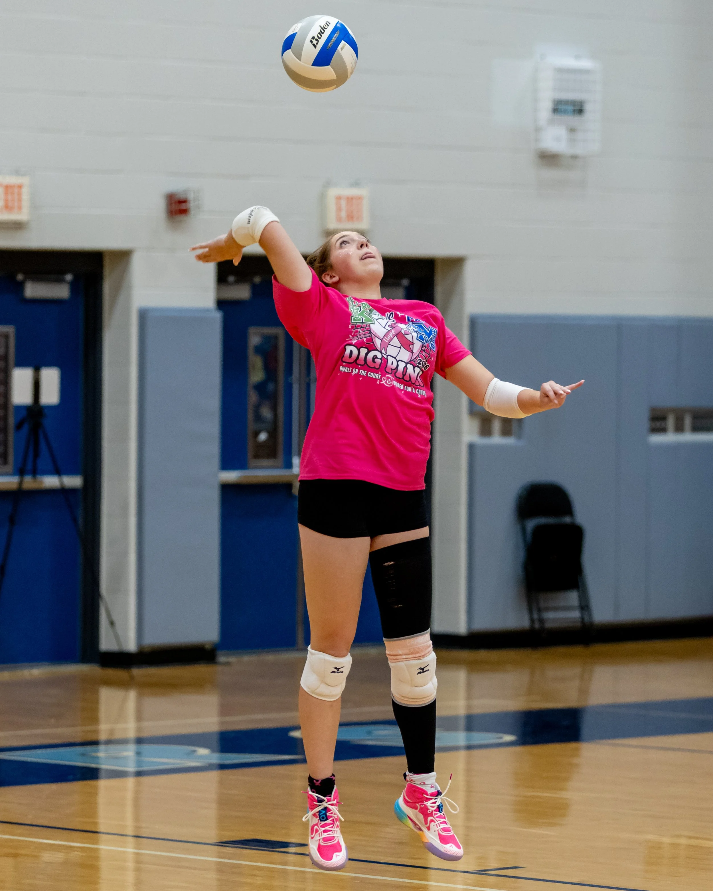 Kettering player serves the ball