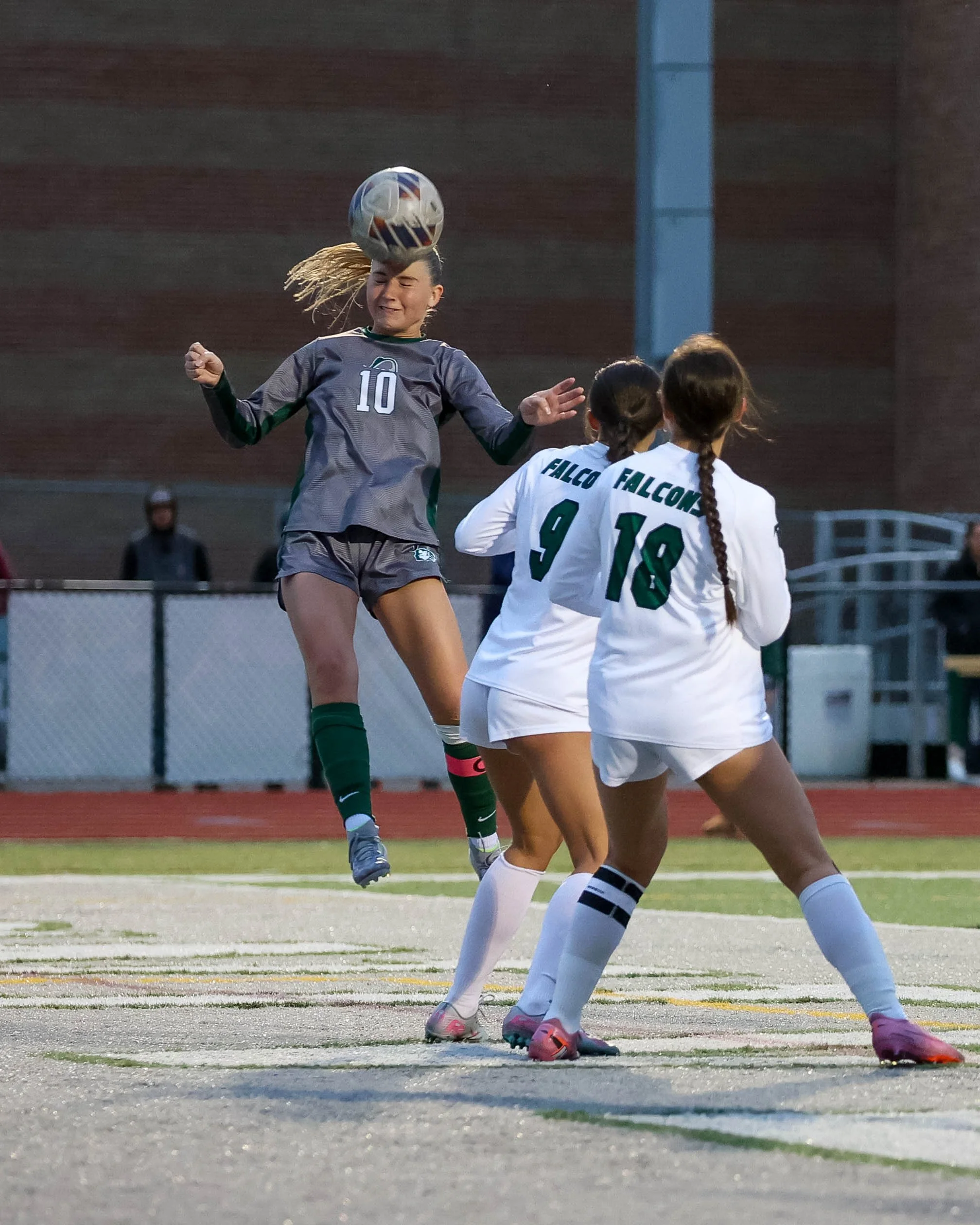 #10 heads the ball