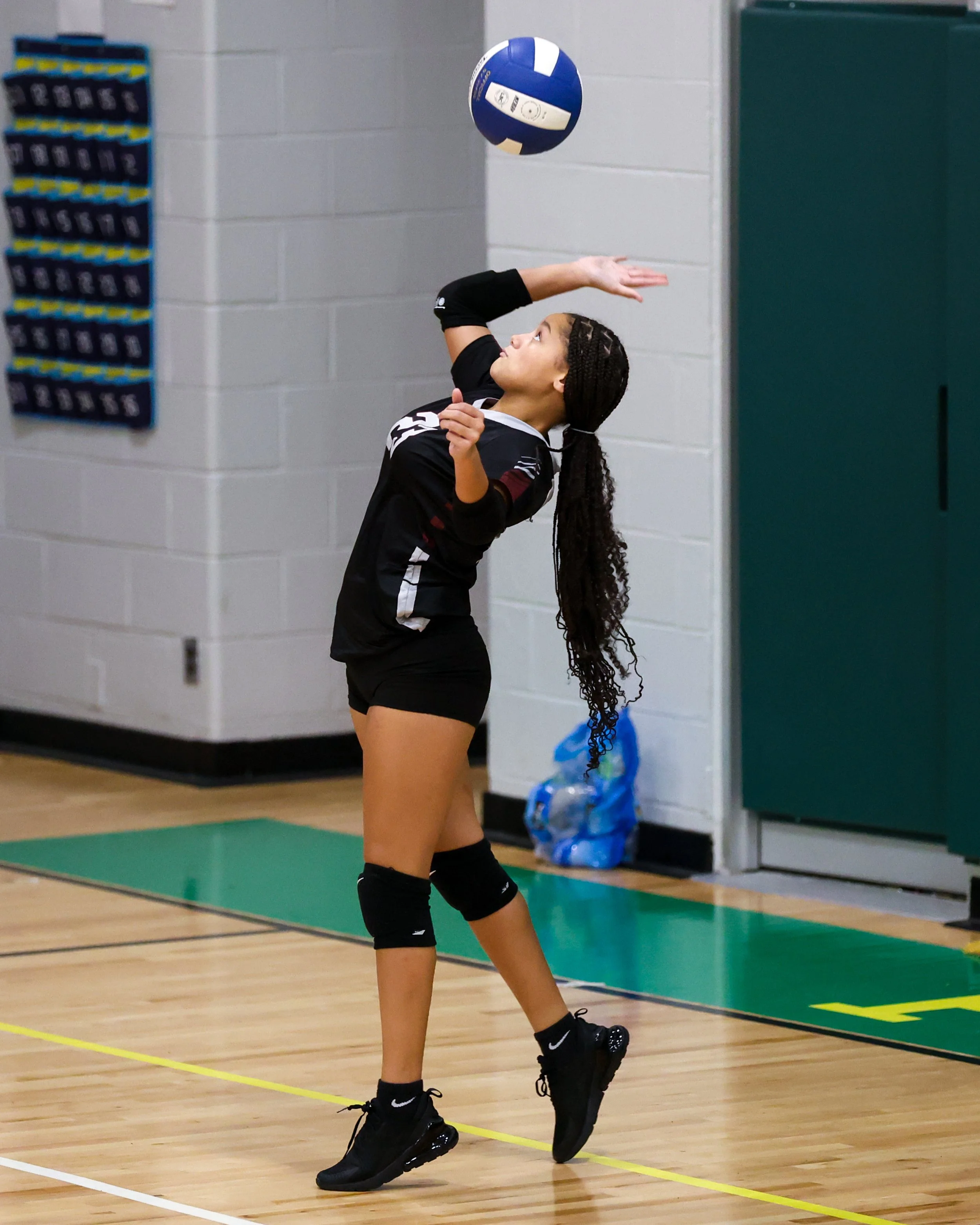 Mason girl serves the ball