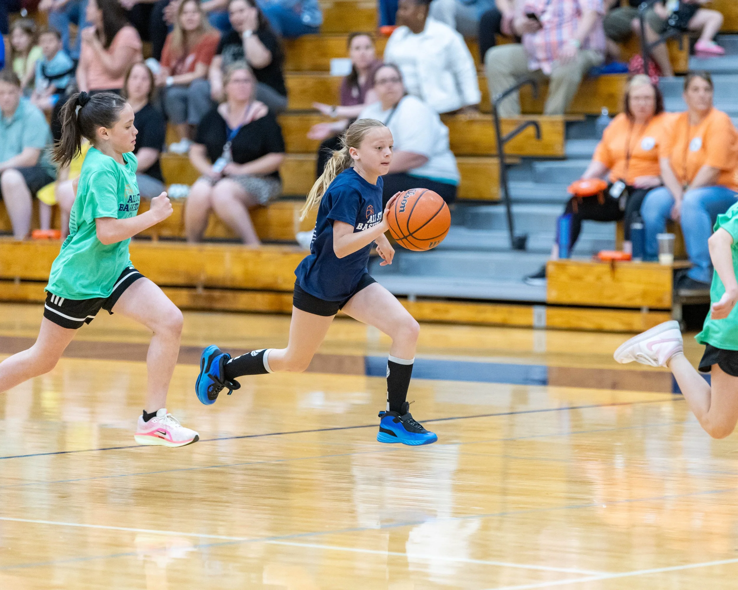 North girl dribbles the ball