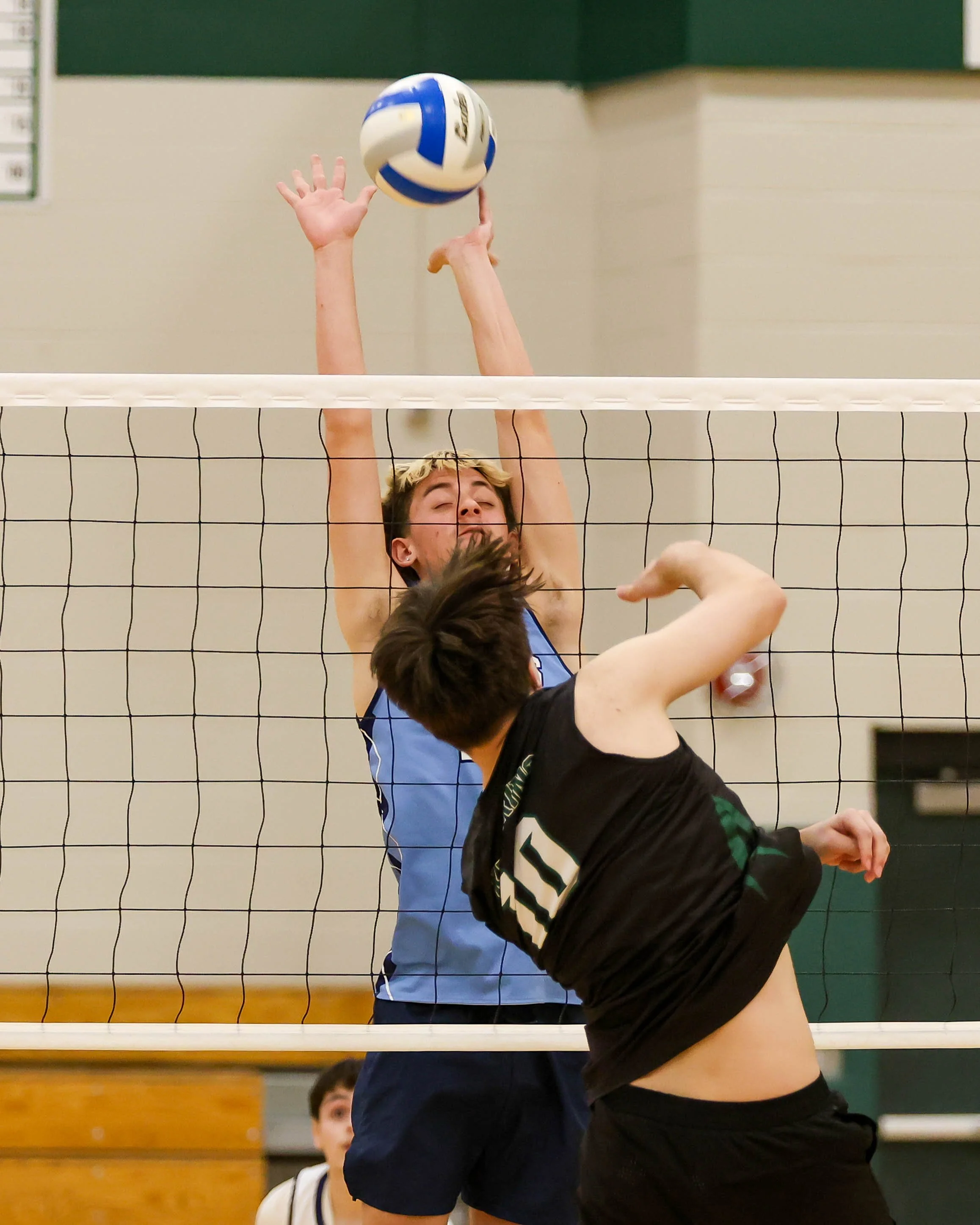 Kettering #10 spikes the ball and Mott #12 tries to block it