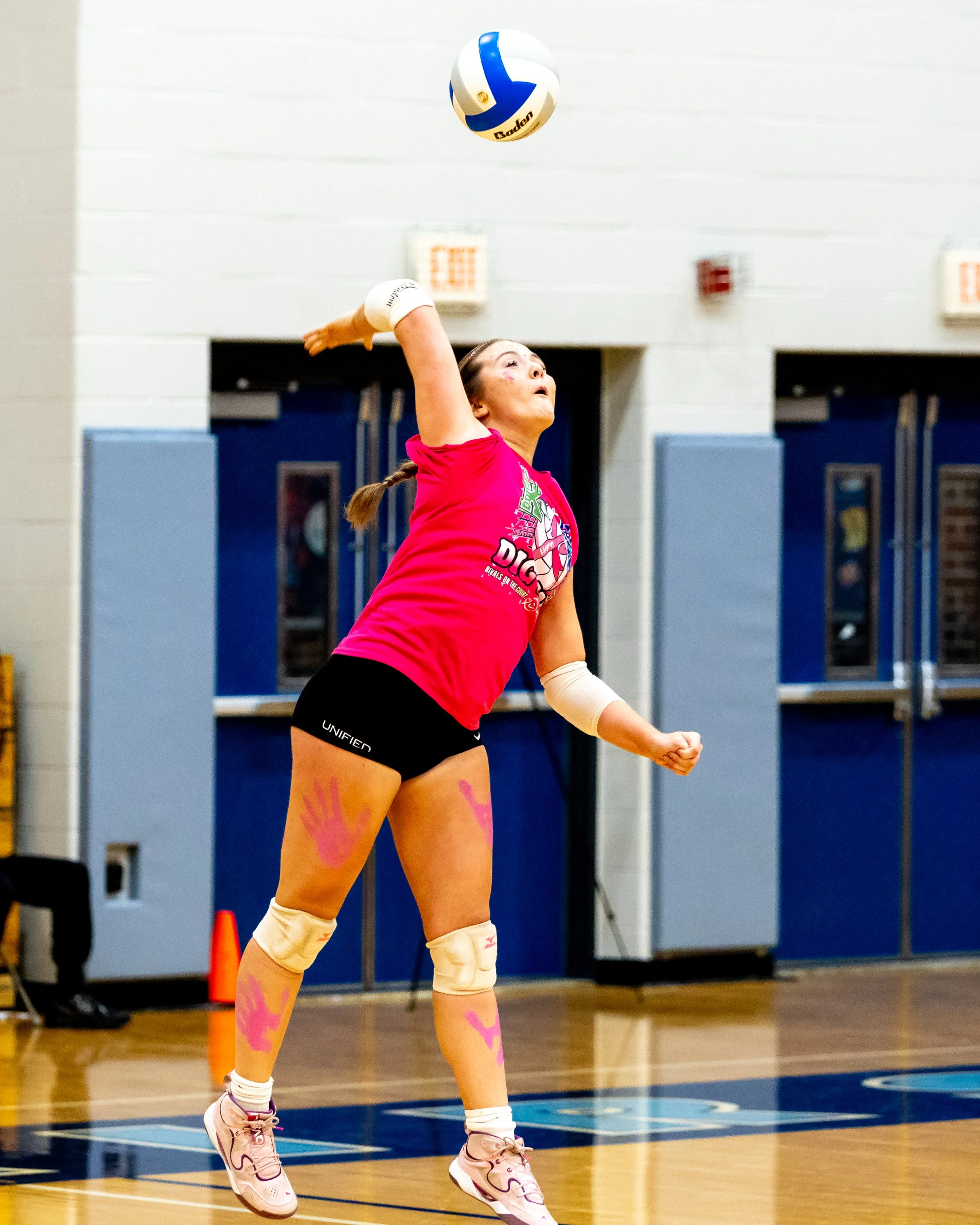 Kettering player serves the ball
