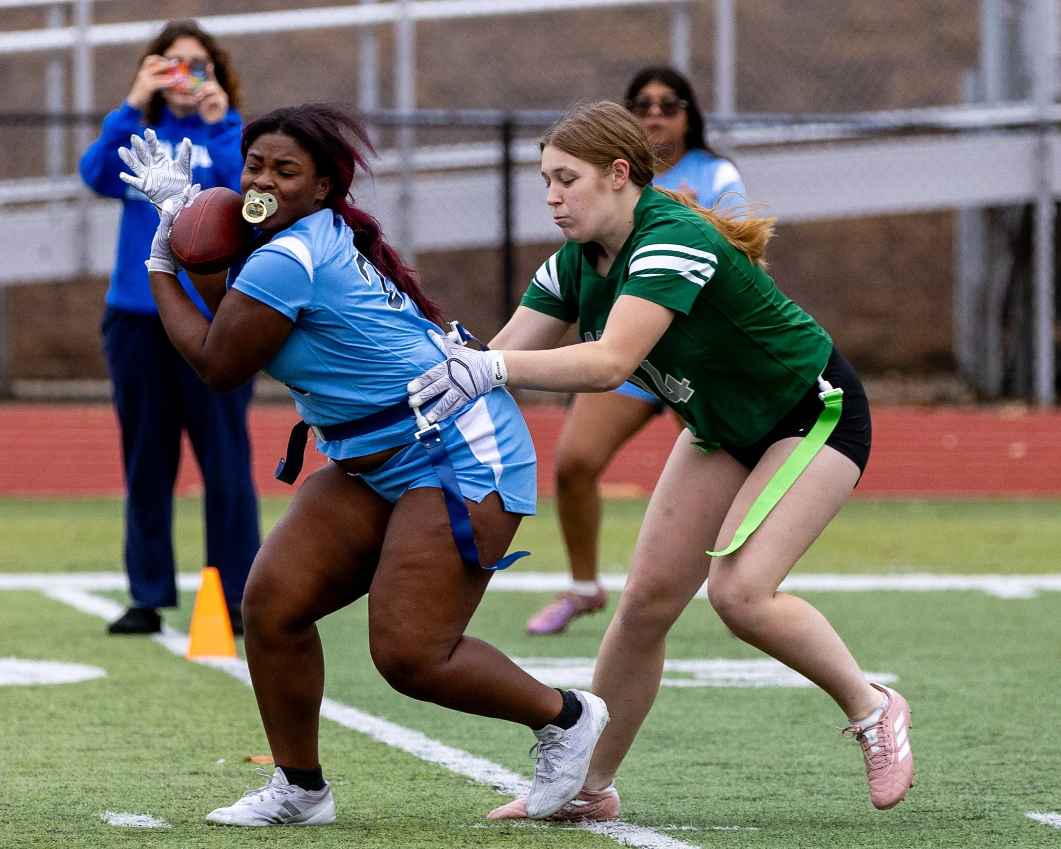 WM #22 run with the ball while WK #14 grabs for her  flag