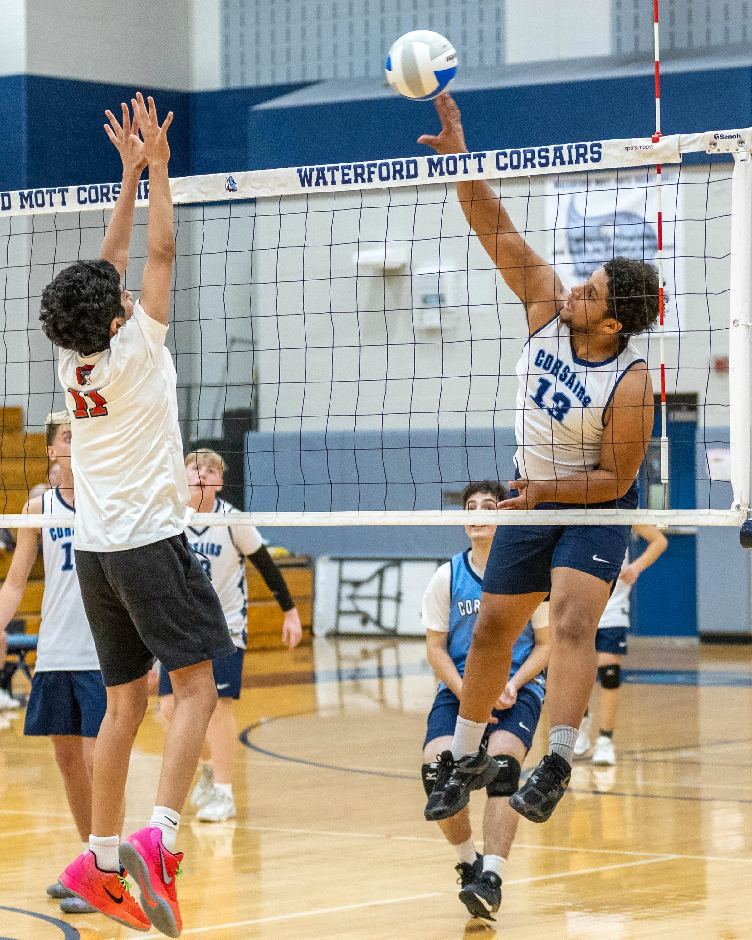 #13 spikes the ball