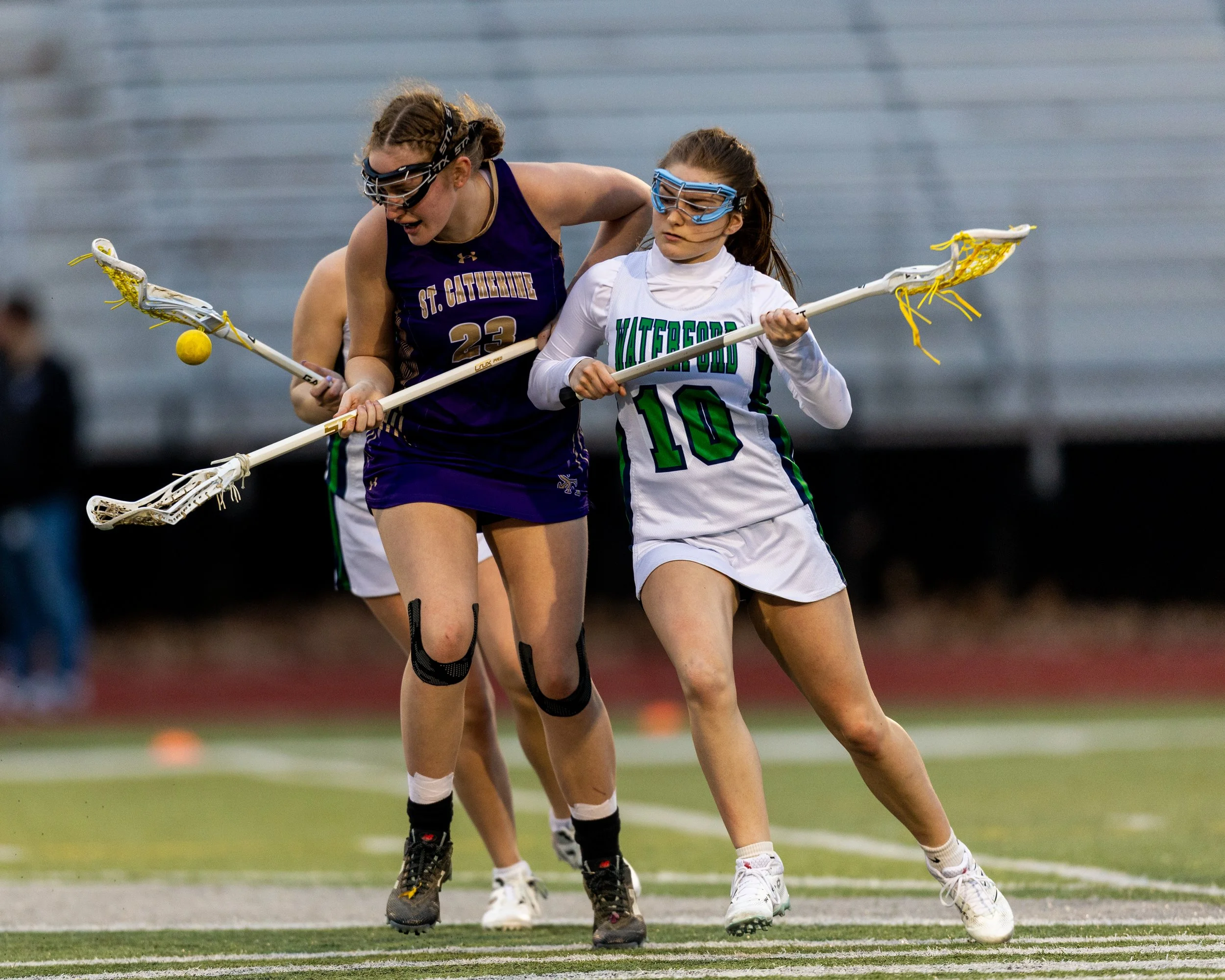 #10 and a St.Catherine's player fight for the ball