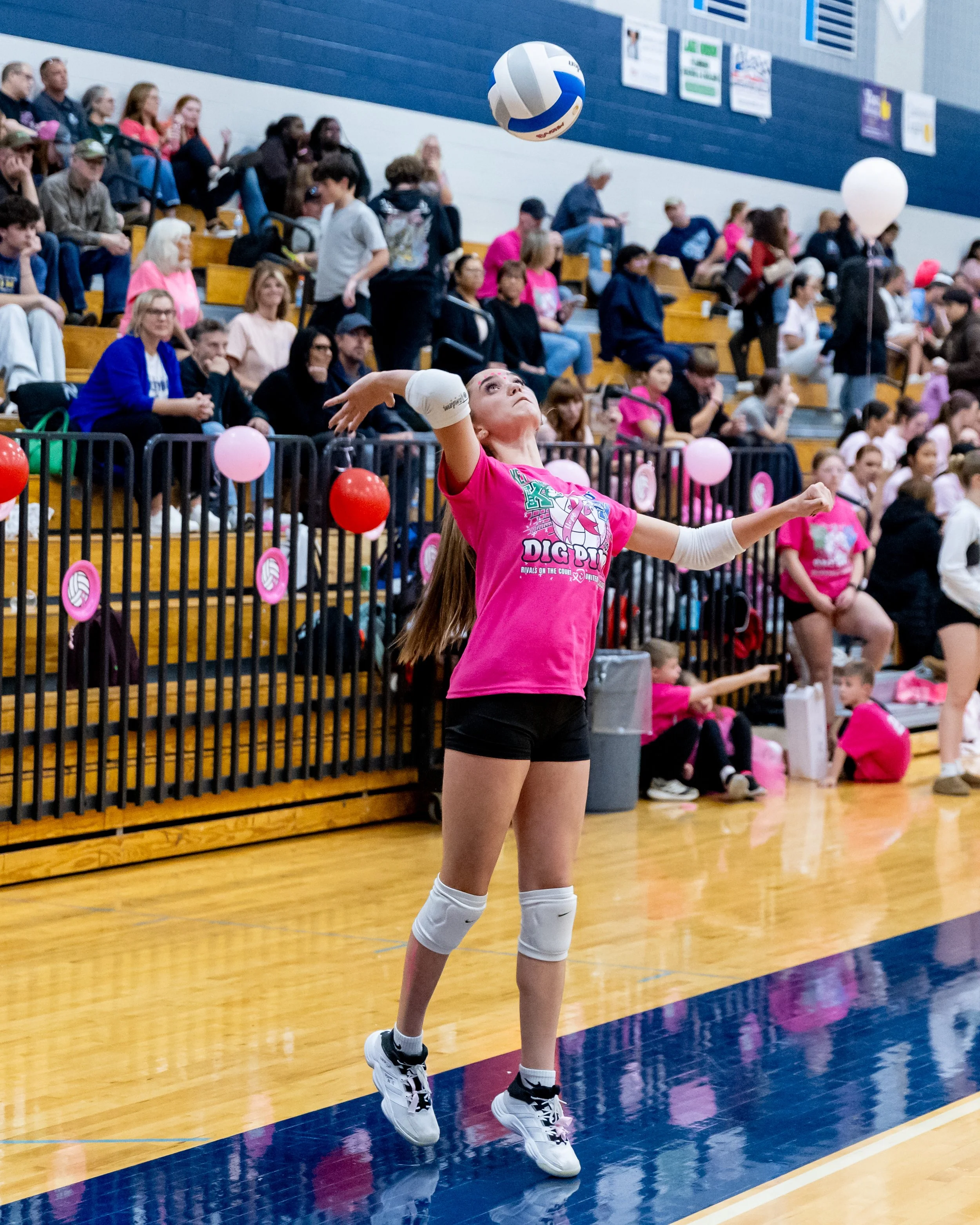 Kettering player serves the ball