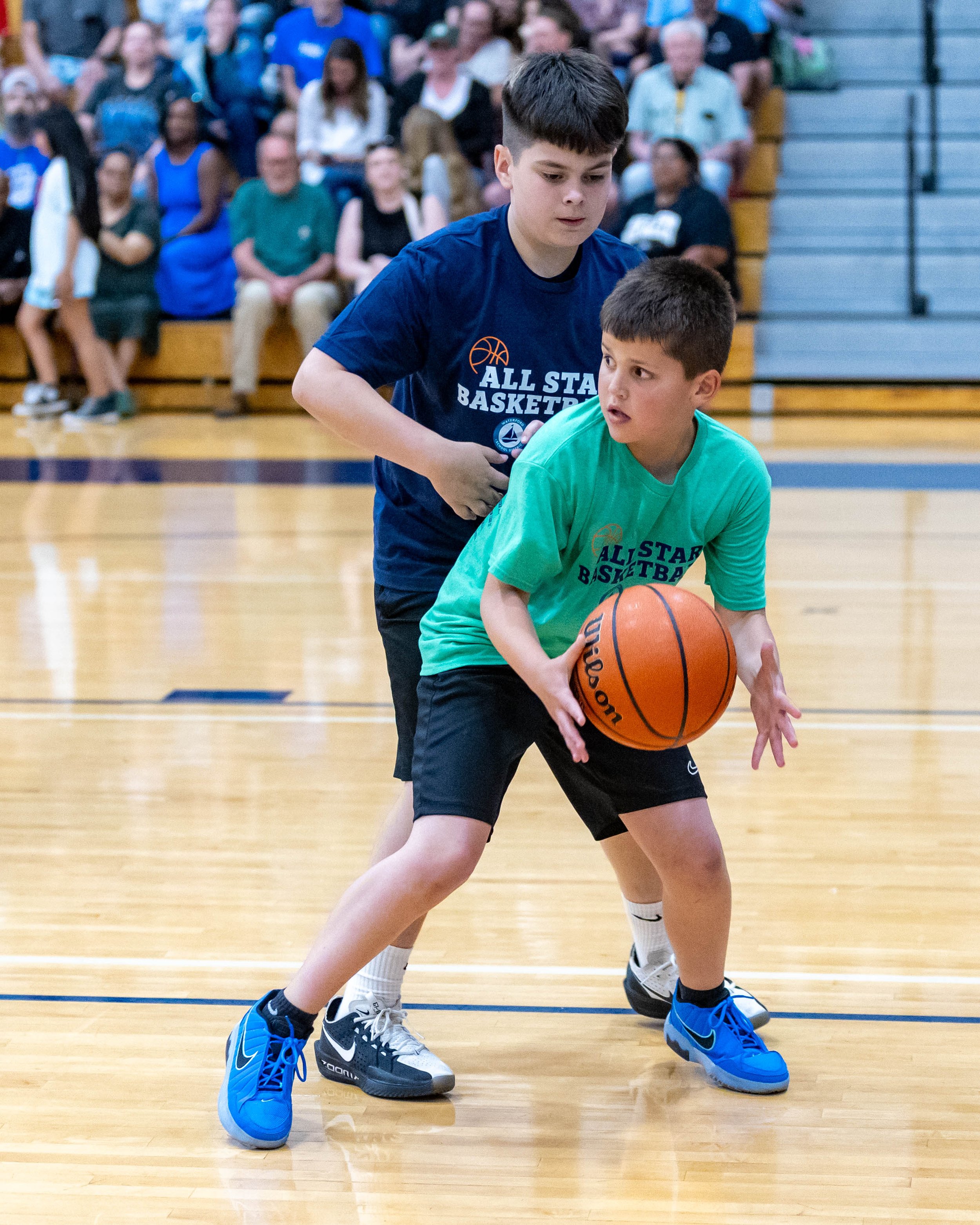 South boy with ball guarded by North player