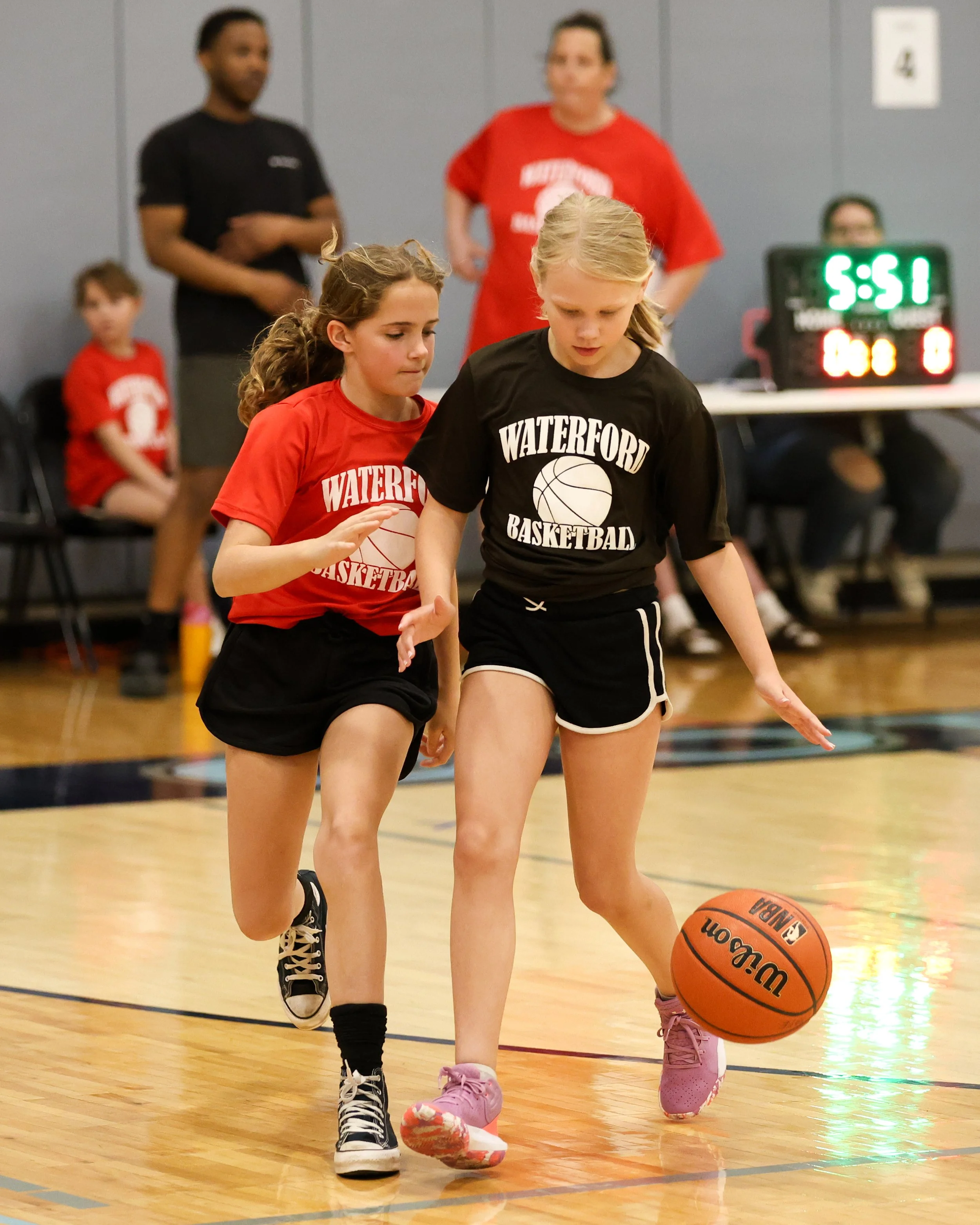 Haviland girl dribbles the ball guarded by Houghton girl