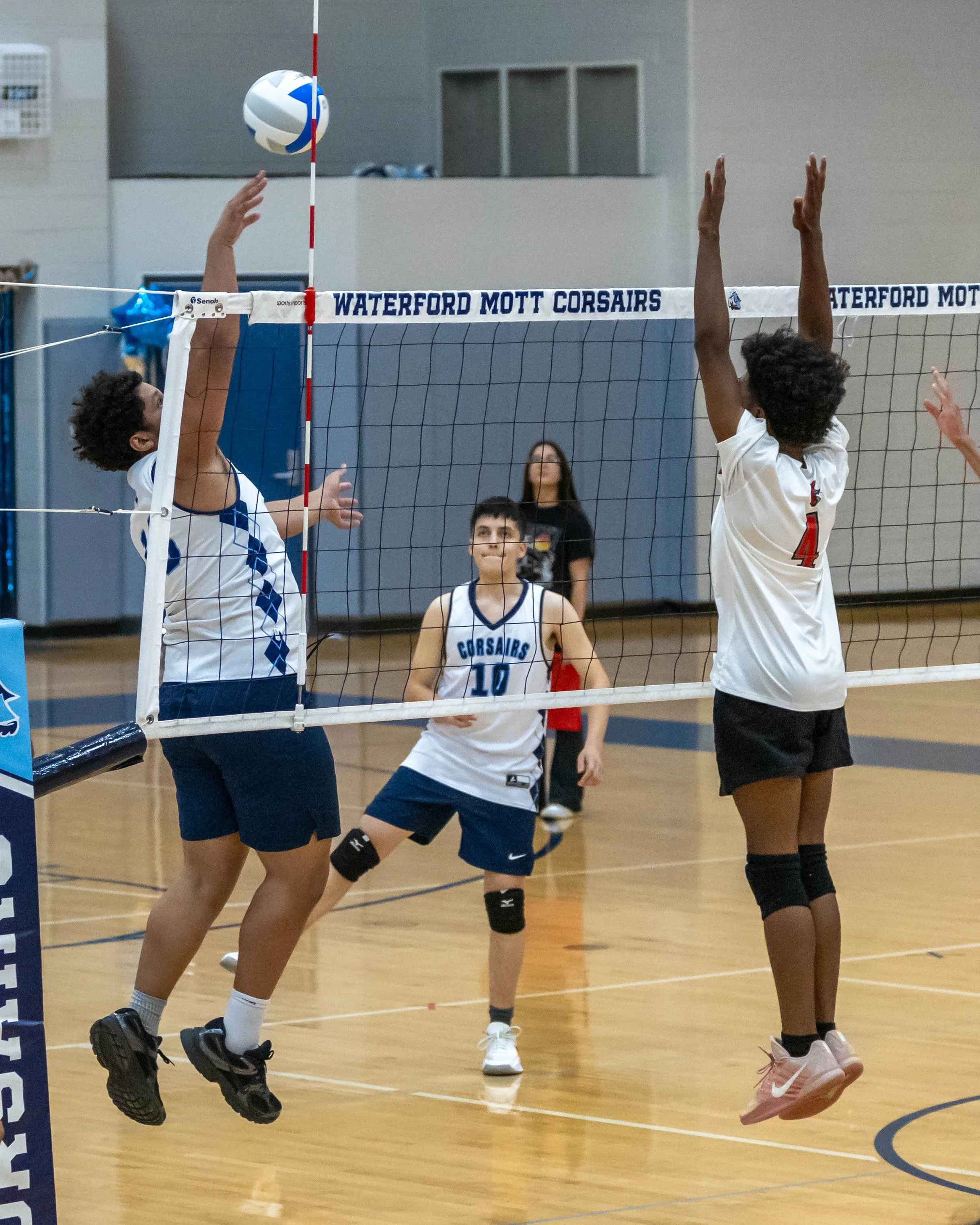 #13 spikes the ball