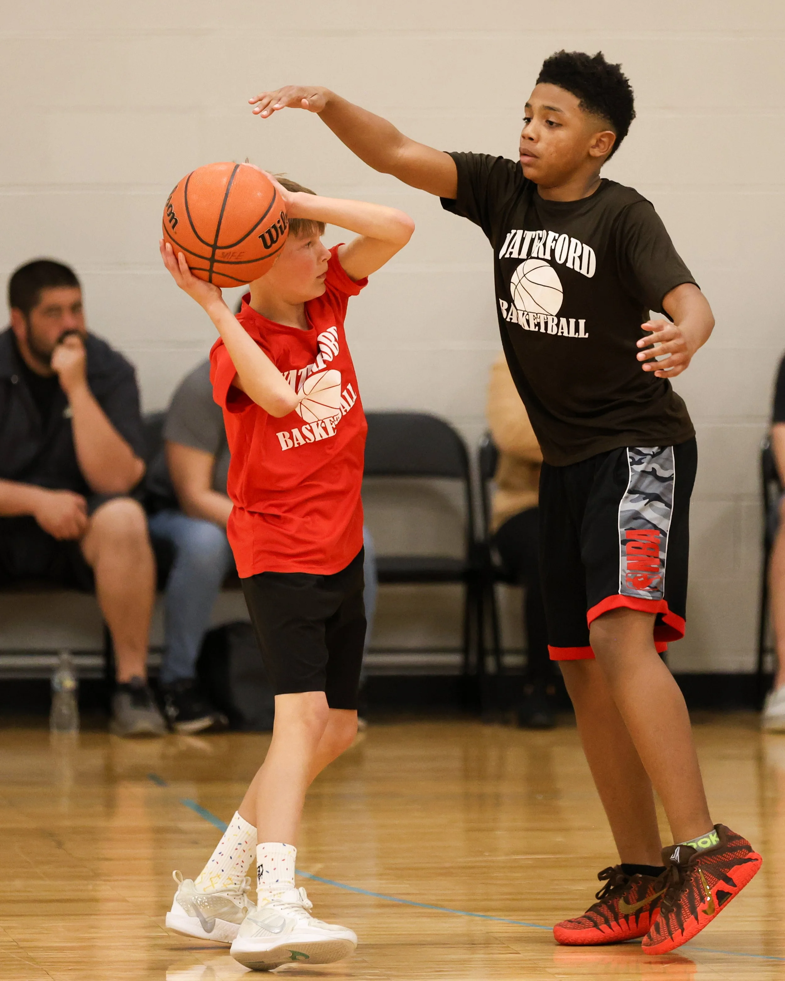 Houghton boy holding the ball guarded by Haviland boy