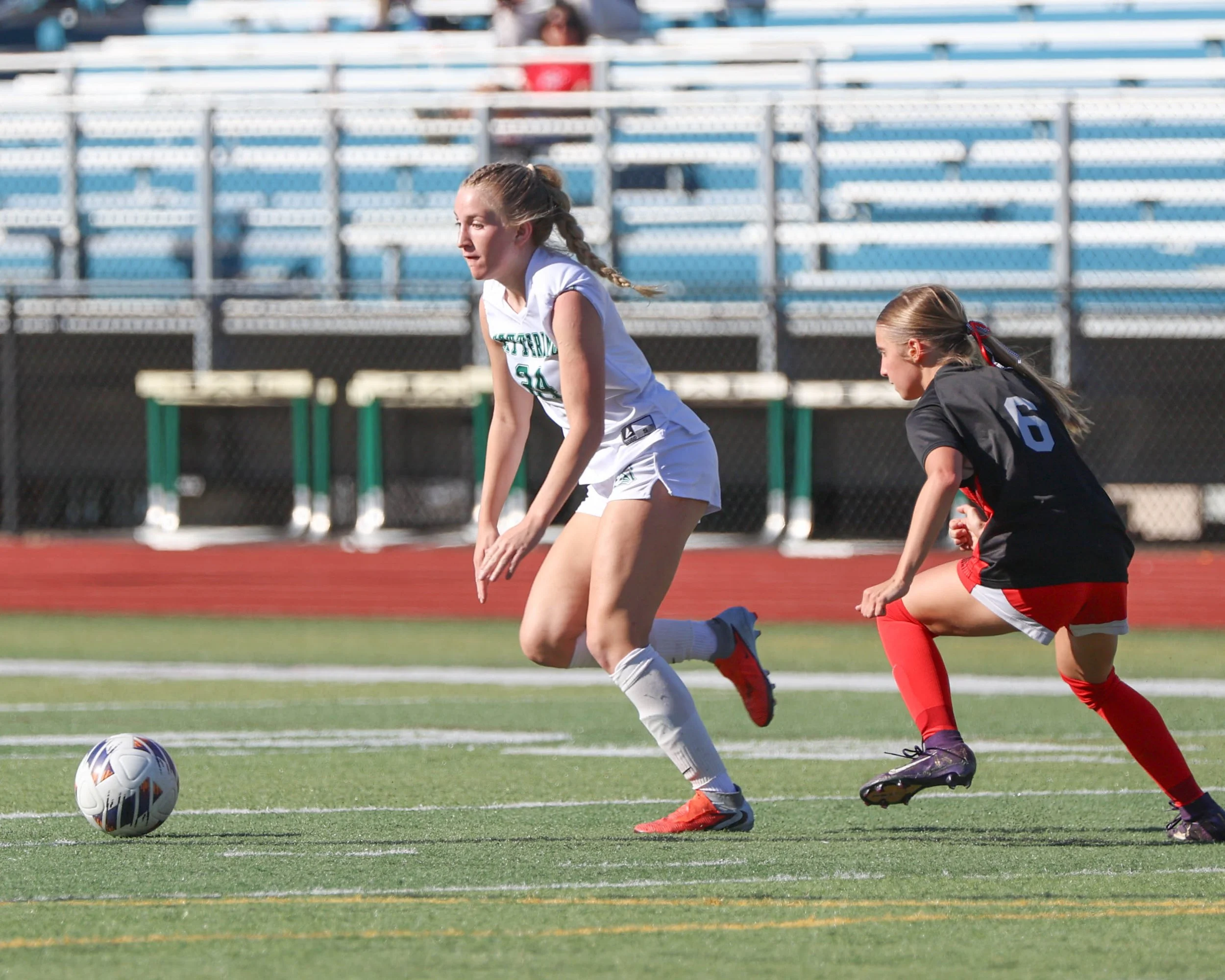 #24 moves the ball past a defender