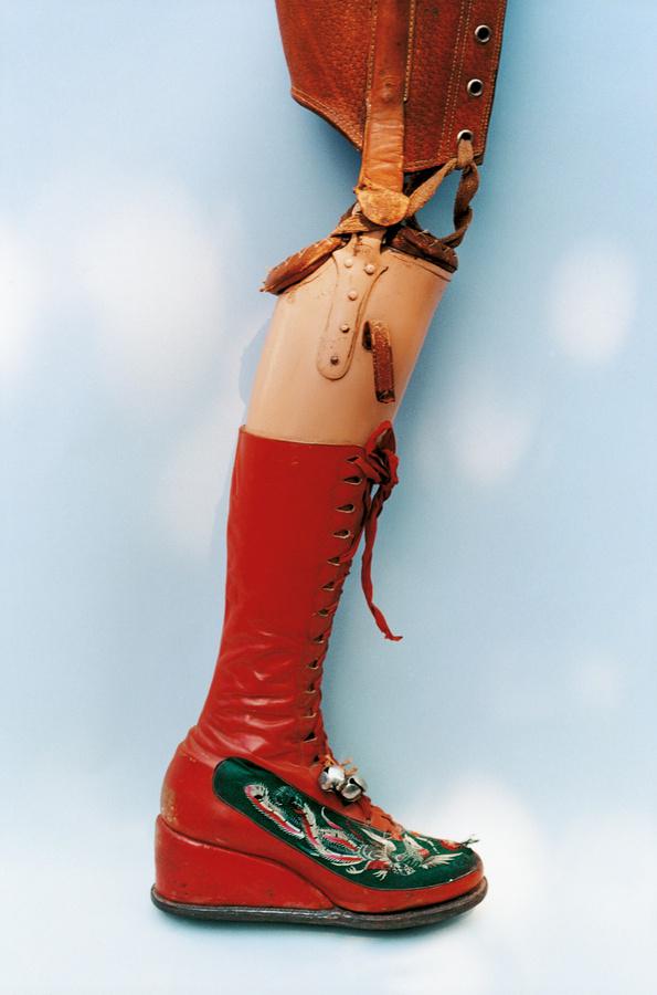 Another piece from the Ishiuchi Miyako exhibit at the Michael Hoppen Gallery . The Guardian , "Kahlo’s leg was amputated in 1953. She designed this prosthetic leg with embroidered red lace-up boots and a bell attached."